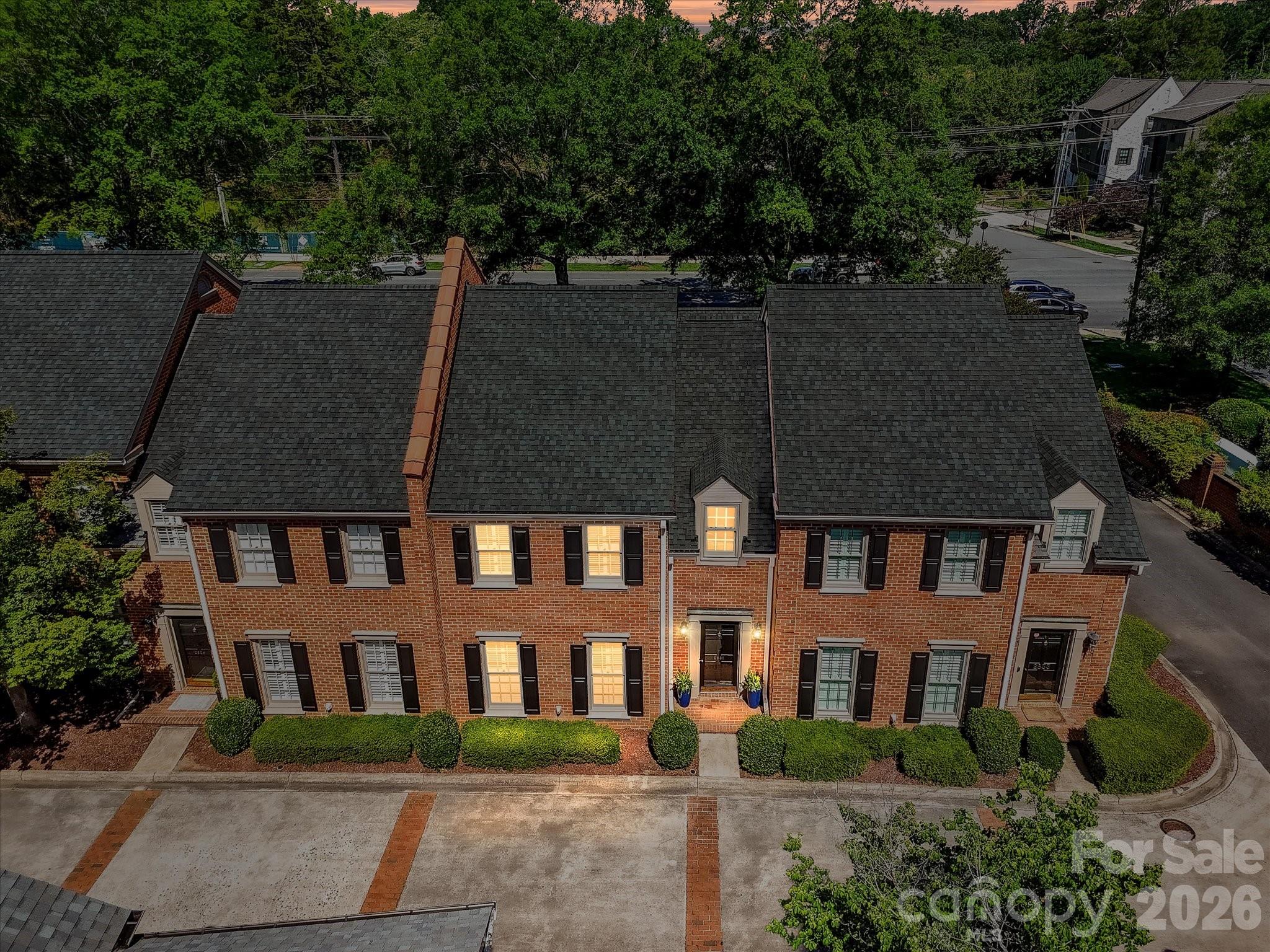 Location! Location! Location! Rare opportunity in one of SouthPark's most coveted enclaves. The Charters, an intimate collection of 30 stately, all-brick, Charleston-inspired townhomes, offers the perfect blend of timeless architecture, spacious comfort, and lock-and-leave convenience.  Spectacular unit boasts a main level Primary Bedroom Suite. Dramatic 2-story foyer, gracious proportions and enduring design. Plantation shutters, gleaming floors, pocket doors and sophistication throughout. Framed by elegant columns, the Formal Dining Room is perfectly suited for both intimate dinners and large gatherings. A classic wood-burning fireplace in the Great Room creates a warm and welcoming space for quiet evenings or entertaining guests. Well-appointed galley kitchen features a collection of premium stainless-steel appliances by KitchenAid, Bosch, and Samsung, providing both functionality and style for everyday living. Upstairs, 2 generously-sized bedrooms with walk-in closets and separate vanities share a well-appointed bath, offering flexible space for visiting family, overnight guests, hobbies, or a dedicated home office. Private terrace provides the perfect outdoor setting for morning coffee, container gardening, or relaxed alfresco dining. Detached 2-car garage offers storage. Recent community capital improvements: newer roofs, gutters, downspouts, asphalt repairs, and brick wall restoration. Moments away from the Charlotte Douglas Airport and Uptown Charlotte. Enjoy unparalleled walkable access to Charlotte's premier shopping, dining, and entertainment destinations. Stroll to Starbuck's, Whole Foods, Phillips Place and SouthPark Mall. Take advantage of SouthPark's complimentary point-to-point ride service available daily from 9am to 9pm. Whether you're traveling more, downsizing thoughtfully, or simply seeking a lifestyle centered on convenience and enjoyment, this exceptional residence offers the freedom to spend less time maintaining and more time living. This is SouthPark living at its finest—elegant, effortless, and undeniably desirable.
