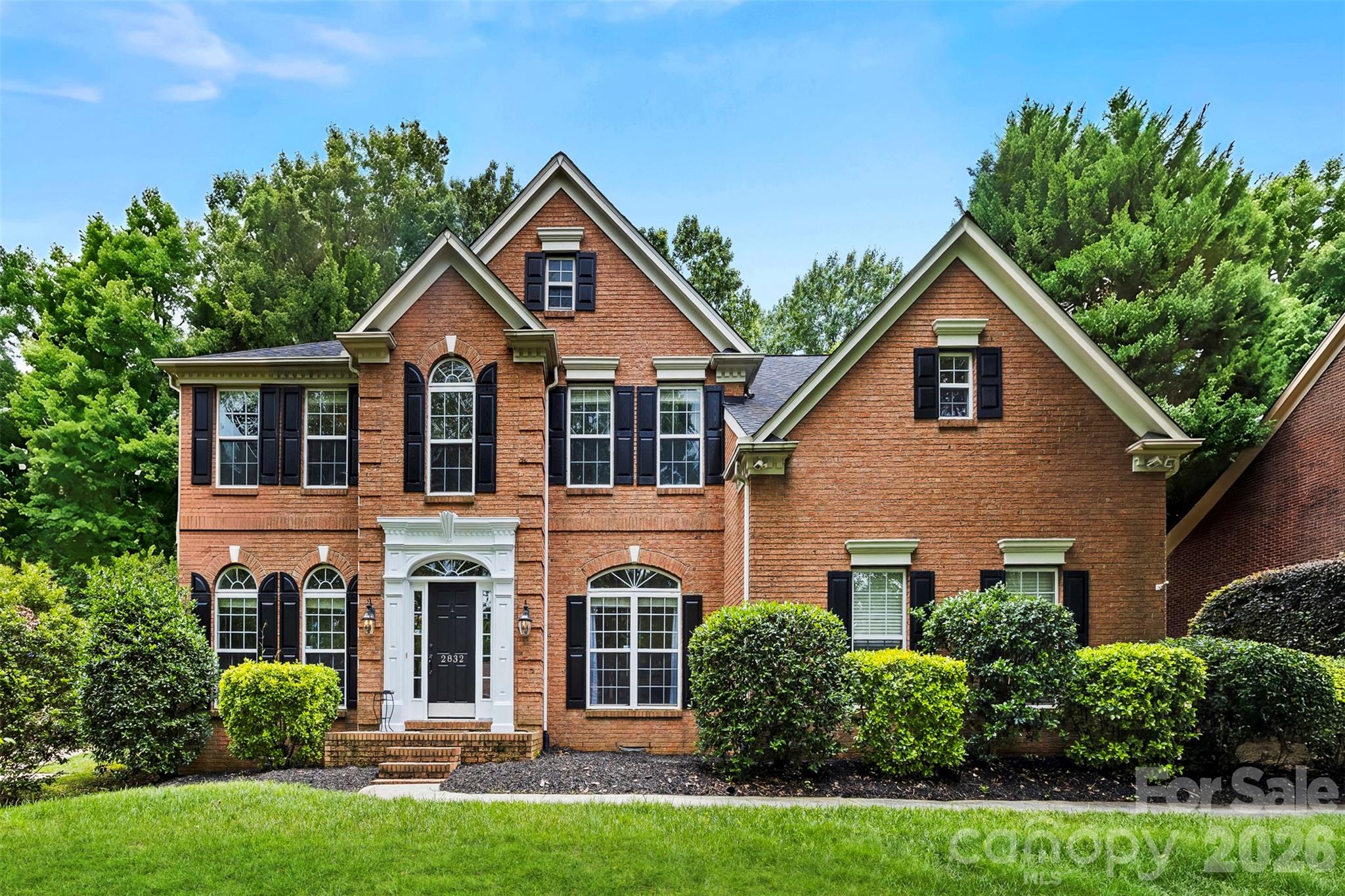 Just 20 minutes from Uptown Charlotte, you'll feel like you've left the city behind.

Tucked among mature trees in the waterfront community of Mt Isle Harbor, this beautifully updated 5-bedroom home offers something that's becoming harder to find... space, privacy, and a slower pace of life without sacrificing convenience.

Here, grab a cup of coffee and start on an oversized screened porch overlooking nothing but trees instead of neighboring rooftops. Evenings can be spent enjoying Mountain Island Lake, relaxing by the community pool, playing pickleball, or gathering with neighbors during community events.

One of the best-kept secrets about Mt Isle Harbor? You can enjoy all the perks of living in a lake community without immediately paying for a boat slip. The neighborhood offers community docks, lake access, a boat ramp, and boat storage, allowing you to embrace the lake lifestyle now and add a boat slip later when you're ready.

Inside, you'll find over 3,200 square feet of thoughtfully designed living space featuring brand-new carpeting, fresh paint, updated lighting, hardwood floors, and a beautifully renovated kitchen with white quartz countertops, a striking blue center island, designer backsplash, farmhouse sink, and abundant prep space.

The flexible floor plan includes a dedicated main-level office plus an additional finished flex space perfect for a home gym, media room, hobby room, guest retreat, or second office. Spacious bedrooms and an oversized primary suite provide room for everyone to have their own space.

Outside, the private half-acre homesite creates a serene backdrop rarely found this close to Charlotte. With no neighbors directly behind the home and mature trees surrounding the backyard, you'll enjoy the kind of privacy that makes it easy to forget you're just minutes from shopping, dining, I-485, Charlotte Douglas International Airport, and Uptown.

If you've been searching for a home that feels like an escape without giving up the convenience of city living, you've just found it.