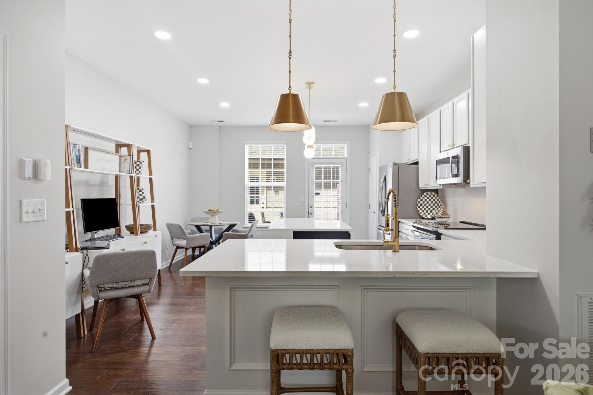 This gorgeous townhome in desirable Antiquity is ready for you! The stunningly upgraded Kitchen will draw you in, and the spacious Living Room and outdoor patio will make you want to stay! This 2-story, 2 BR, 2.5 Bath beauty is looking for a new owner to share itself with! It welcomes you in with magnificent engineered hardwood floors. The bright, open LR/Kitchen/Dining is convenient for every day living and entertaining. The Kitchen's makeover included an overhaul of the cabinets, newly installed quartz countertops with widening of the countertops at the new elongated single bowl sink and at the island to enhance the prep/eating/hosting space, replacing appliances, installing new hardware, updating light fixtures, and installing dimmable recessed lighting. The space is now chef-friendly, functional, and fabulous!  The interior was completely painted, including doors and trim, and there's a new Living Room ceiling fan with remote. Outside, a stamped concrete patio was installed for easy maintenance and outdoor enjoyment. The 1-car garage is just steps away to cover your parking and/or storage needs. Upstairs you will find 2 well-sized BRs with admirable closet space, 2 full Baths, and a stackable washer/dryer. The Antiquity n'hood has what you've always dreamed of--tree-lined streets, pool & clubhouse, dog park, greenway, and shopping, dining, & personal services that you don't have to drive to! Harris Teeter, sushi, tacos, pizza, burgers, nails, hair, teeth, health--it's all here! PLUS LOCATION! LOCATION! LOCATION! Cornelius Town Hall, Farmer's Market, & shops, Cain Center for the Arts, Act It Out Studio! Charming Downtown Davidson with Davidson College, social district, & exceptional restaurants! Beautiful Lake Norman and all it's fun activities! Come see it and explore the area today!