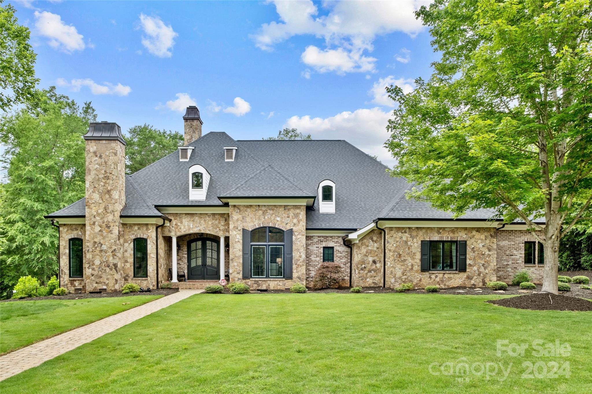 Stunning custom home on a gorgeous & private 2.2 acre lot in the prestigious gated community of Farrington! Classic gas lanterns welcome you into the open floor plan with soaring ceilings, an abundance of natural light from the floor-to-ceiling glass, warm hardwoods, etc.! The chefs kitchen overlooking both the great room & the welcoming backyard includes quartz counters, an induction cooktop with steel hood, double oven, etc.  The family room showcases a gas fireplace & built-ins, leading to a covered patio, luxurious swim spa, & breathtaking backyard! Stunning primary bed with access to the patio, and a spacious spa-like ensuite bath.  Secondary gas fireplace w/a wet bar provides additional entertaining space.  Luxury meets location!