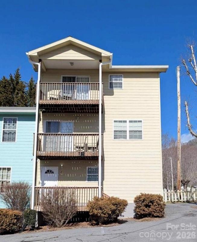 Escape to mountain living! This 3-bedroom, 2.5-bath Burnsville townhouse boasts mountain views from two private balconies. Enjoy a convenient location near downtown Burnsville, the Parkway Playhouse, a recreational park, and a city pool. This end-unit features a 1-car garage, a modern open floor plan in the living area, and the ease of city water & sewer. Low maintenance living makes it perfect for families or an investor.  Easy access to hiking, fishing, and the cultural attractions of Burnsville and Asheville are all within easy reach. Whether you're seeking a family haven or an investment, this property is a must-see!