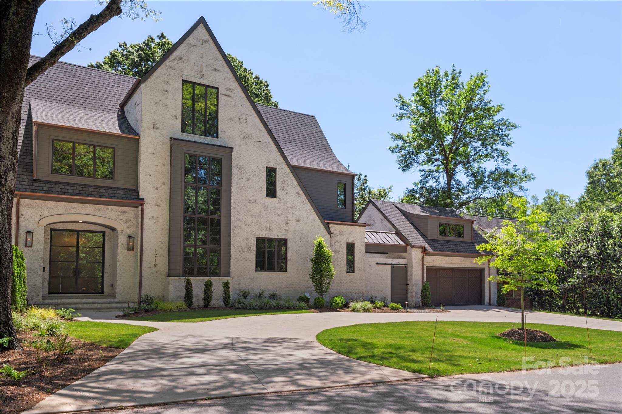 This exquisite 3-level estate in a prime Charlotte, NC location offers 5 beds, 5.5 baths, and unmatched luxury throughout. Premium details include copper gutters, Emtek marble-lever hardware, and wide-plank hardwoods. The chef’s kitchen stuns with a Statuario Crystal quartzite island, Brazilian Mist counters, Wolf 48” range with brass bezels, Sub-Zero wine column, Brizo faucets, custom cabinetry, and a walk-in pantry. Floor-to-ceiling sliders open to a resort-style patio, pool, and fireplace—perfect for entertaining. The main-level primary suite boasts a spa-like bath with heated tile floors, dual vanities, and a custom closet. Additional highlights include a scullery, designer lighting, upper-level family room, sitting room, detached guest suite, and an expansive fenced yard. Every space is meticulously curated for refined living, just minutes from Charlotte’s top dining, shopping, and schools.
