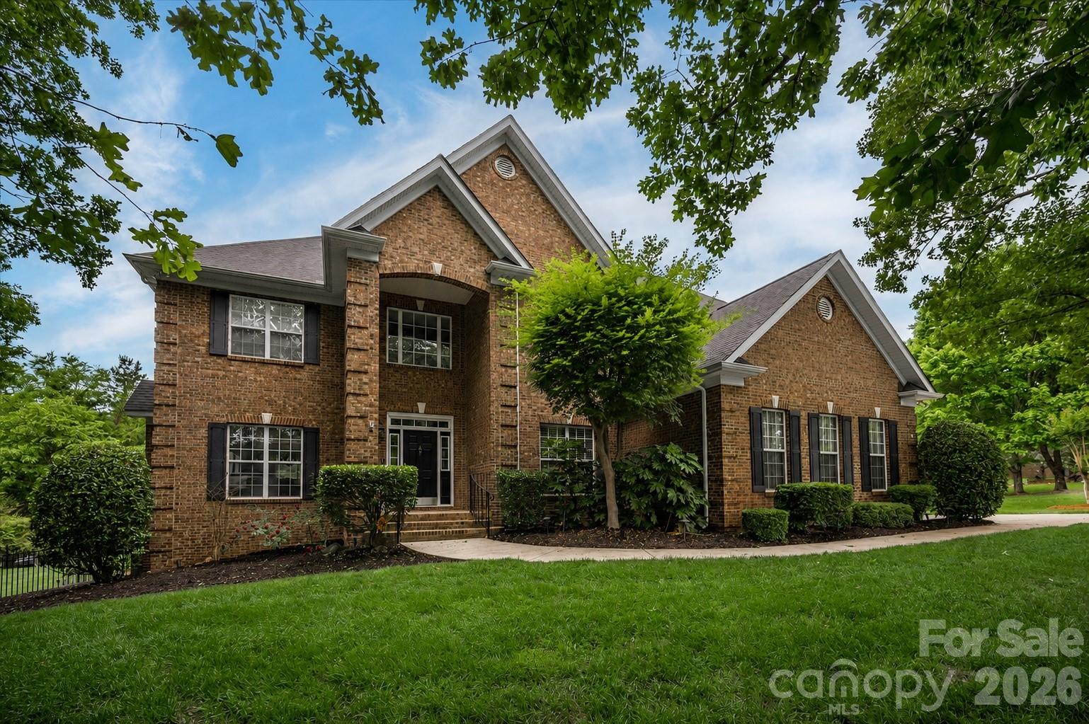 Located in the heart of Waxhaw within the prestigious Marvin school district, this 5-bedroom, 4.5-bath estate delivers an exceptional blend of comfort and scale. Spanning over 6,000 square feet, the home beautifully balances everyday living with expansive spaces for gathering. Surrounded by mature trees on a private homesite with neighbors on only one side, it offers unmatched serenity and privacy.

Step into a dramatic two-story foyer showcasing a striking staircase. The main level flows effortlessly between the family room, formal dining room, breakfast nook, dedicated office, and a chef’s kitchen. Just past the kitchen, an inviting screened porch outfitted with EZ Breeze windows, a ceiling fan, and a TV overlooks a stunning backyard oasis for a seamless indoor-outdoor transition.

The primary suite is a true retreat, boasting heated bathroom floors, dual walk-in closets, and a spa-inspired bath where a strategically placed television can be enjoyed from both the soaking tub and the shower. Upstairs, spacious secondary bedrooms and a media room provide plenty of room for relaxation. Meanwhile, the walkout basement serves as its own private destination. Complete with high ceilings, a fully equipped second kitchen that rivals most primary kitchens, a golf simulator, recreation areas, and a luxurious guest suite featuring a spa bath, an oversized shower, and a custom infrared sauna, making it ideal for extended stays or multigenerational living. The lower level seamlessly extends outdoors to a chic covered lounge, complete with a cooling fan and the perfect setup to catch the weekend game, creating the perfect space to relax, sip a drink, and take in the serene setting before stepping out into the sun.

The jewel of this property is the resort-style backyard. Framed by lush landscaping and natural privacy, a sparkling pool features a waterfall, diving rock, and hot tub, surrounded by expansive patio space. Whether enjoying a quiet morning by the water or hosting unforgettable summer gatherings, this outdoor retreat is designed for making memories.

Additional highlights include a 3-car garage, a hardwired speaker system, and abundant storage across all three levels. Filled with years of cherished memories and thoughtfully designed for connection and entertaining, this exceptional property offers a rare opportunity to own one of Waxhaw’s most inviting lifestyle homes.