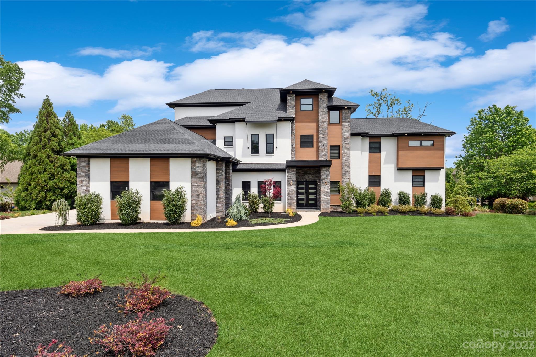 Contemporary design at its finest! Boasting nearly 9000 square feet of flawlessly designed living space, every detail of this home has been meticulously crafted, creating a perfect setting for both everyday living and lavish entertaining. Every detail of this incredible home was meticulously deigned and flawlessly executed. Just minutes away by boat, enjoy the amenities of The Point Tavern, Clubhouse, and Spa or relax in the tranquility of the large, calm water cove, ideal for lake lounging, swimming, and paddle boarding. Enjoy stunning lake views, undulating fairways, and meticulously manicured greens at the Greg Norman signature golf course or sneak in a quick round at the newly installed Fazio Five short game complex A deeded boat slip located directly behind the home fosters neighborly chats and requires practically zero upkeep and a second slip is available for for lease w/ option to buy.  *See Agent Remarks in MLS.