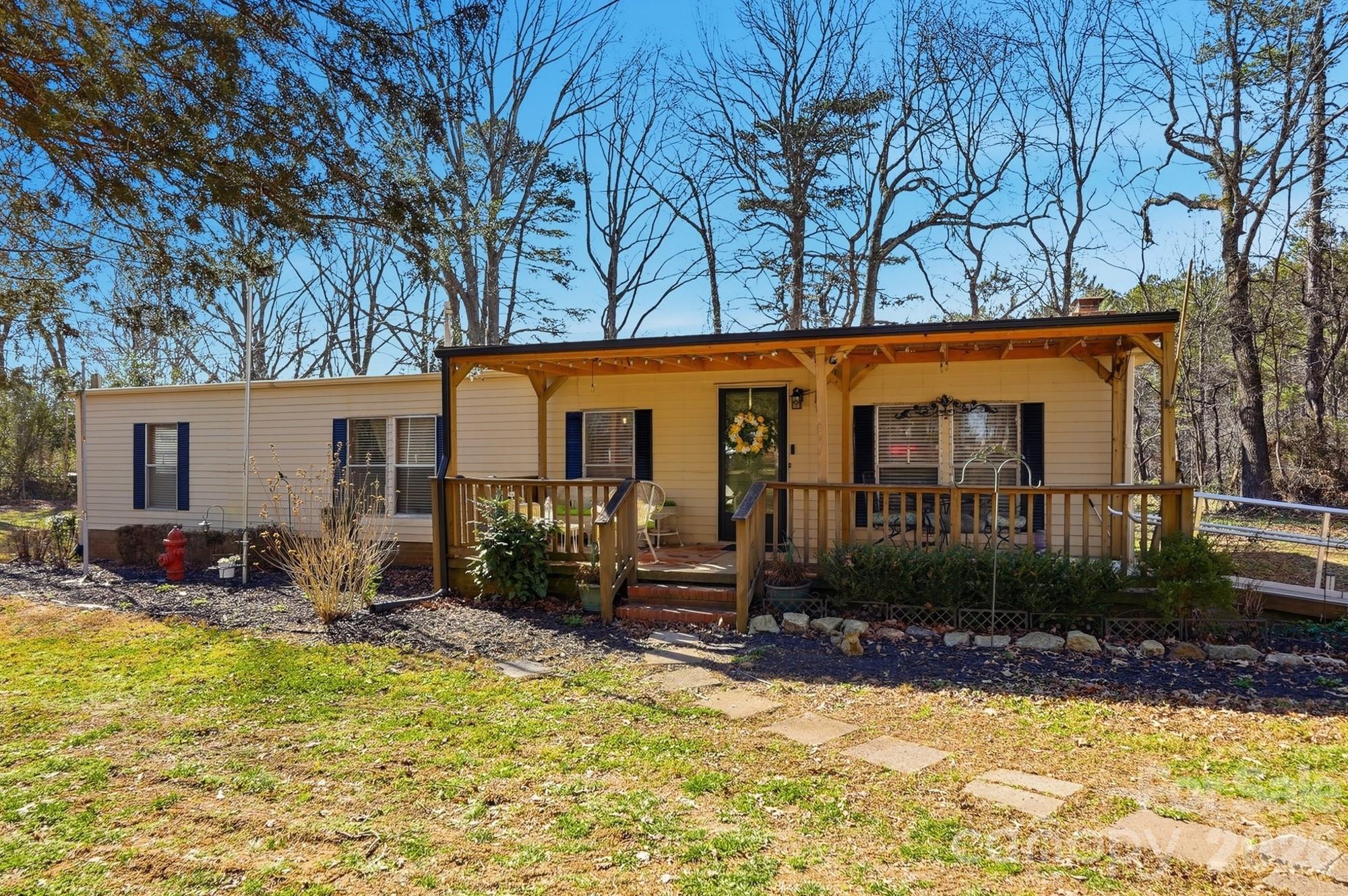 NOTE : Also listed under Land under MLS#4358232 on 3/17/26. PRICE IMPROVEMENT! Don't miss this 3BR/2BA home on .74 acre in Dallas! This 1440 sq ft manufactured home includes a bright, updated kitchen, newer laminate flooring and a separate dining room. Besides the living room, there is also a large family room with sliding doors accessing the porch and back yard. The home includes three large bedrooms. Per seller, the roof was cool sealed in 2022, and the septic system was last pumped in 2023. 2010 HVAC. Let's talk about the DETACHED GARAGE! This 30x50 building can house multiple vehicles, store just about anything you can think of, or become a functional workshop. Fireplace has not been used in years, per seller. Home and buildings sold as-is. Peaceful, private corner lot with easy access to Gastonia. NOTE: Due to the manufactured home being built in 1973, this has to be a CASH purchase. Thank you!