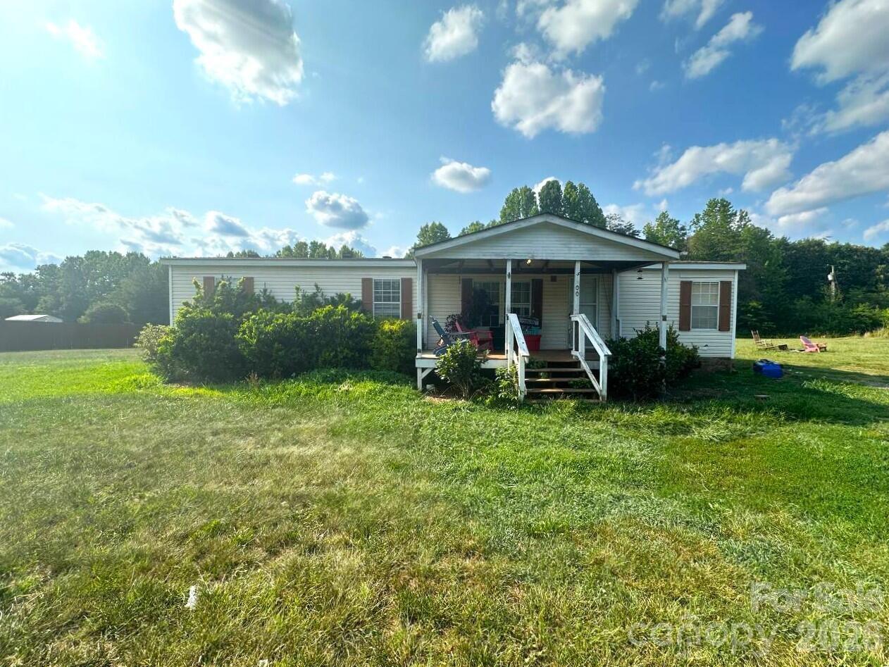 Manufactured home on owned land in Lincolnton with 3 bedrooms, 2 bathrooms, and 1,417 sq ft on just over 1 acre. Features include a covered front porch, spacious yard, vinyl siding, 2-car carport, private water, septic, and heat pump/HVAC. Interior includes LVP-style flooring, open living and dining areas, and an updated kitchen with painted cabinetry, tile backsplash, granite-style countertops, stainless steel appliances, and center island. Available information indicates the roof and HVAC were replaced within the last 10 years and the foundation was inspected in late 2023 with no known major issues. Some cosmetic repairs may be needed.