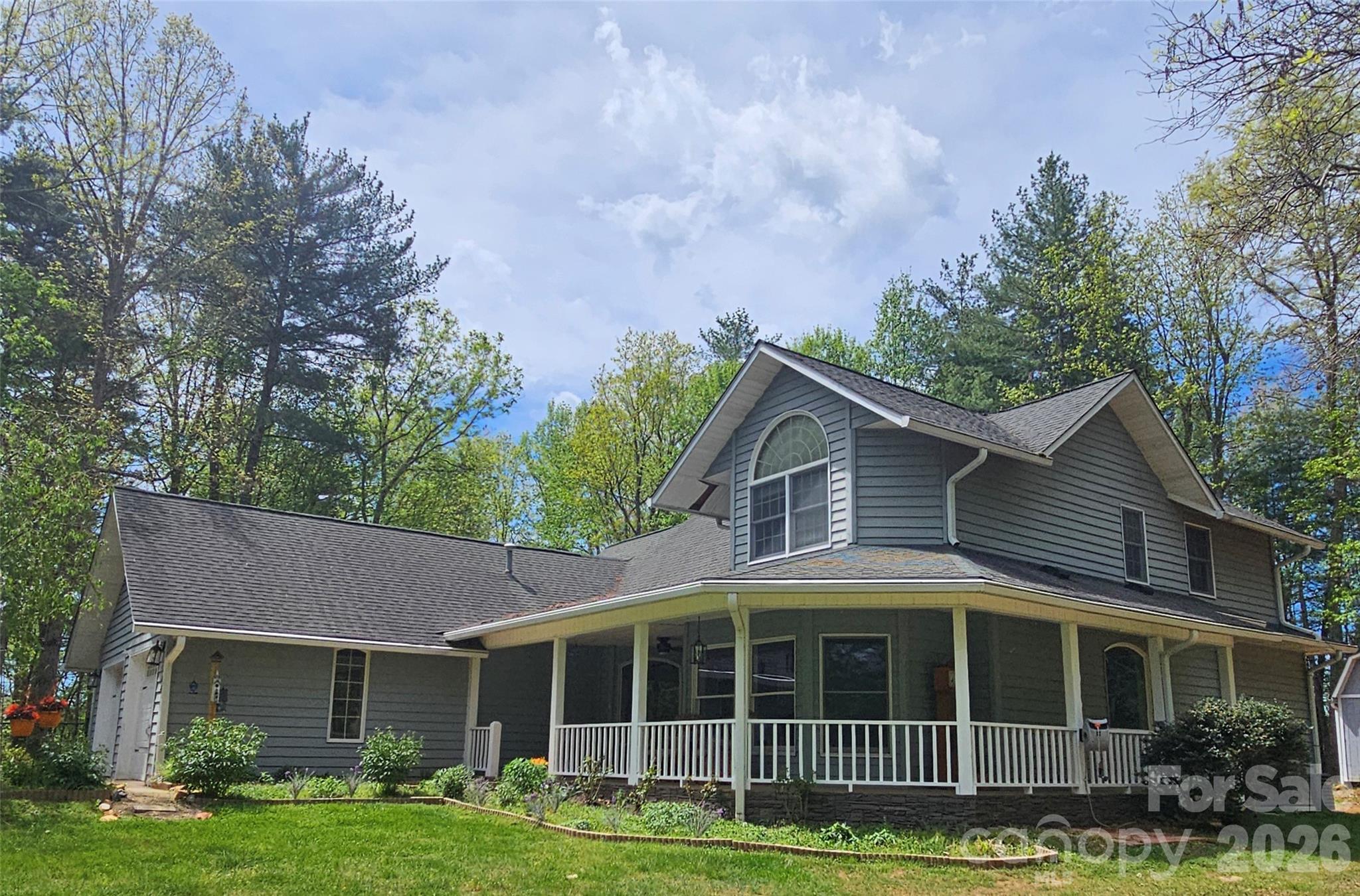 Flat, Usable Acreage Near Asheville – Move-In Ready Farmhouse
This move-in ready 3BR/2.5BA farmhouse with 2-car garage sits on 1.94 acres with space to garden, roam, or bring family together. Main-level primary suite, vaulted ceilings, and a fully renovated kitchen with Bosch appliances and custom master ensuite with walk in closet.

Enjoy privacy without isolation—ideal for homesteaders, families, or those looking to spread out without sacrificing convenience.

New price—positioned to sell.

The newly renovated kitchen offers wood beams in the ceiling, ALL Bosch appliances, gas range and vented hood, soft-close cabinetry. Open concept which flows into a cozy living area with the beautiful floor to ceiling natural stone, wood-burning fireplace. The primary ensuite is a true retreat with a total bathroom/closet renovation. Including a glass-enclosed steam shower, cast-iron soaking tub, bidet toilet (enclosed with pocket doors), soft-close cabinets, and designer walk-in closet. Through the pocket-doors from ensuite is access to a bright private office overlooking the front yard with abundant natural light. 2-car garage.
Additional features include well + septic, central HVAC, appliances, washer and dryer included, and a whole-house water filtration system located in the crawl space.

Enjoy outdoor living with a wrap-around front porch and open back deck, plus fire pit, fenced garden space, fruit trees, mature trees, and two storage sheds. Pet-friendly features include a large fenced-in side yard with dog-door access to both the home and garage, along with an invisible fence surrounding the full 1.94-acre perimeter (two collars included).