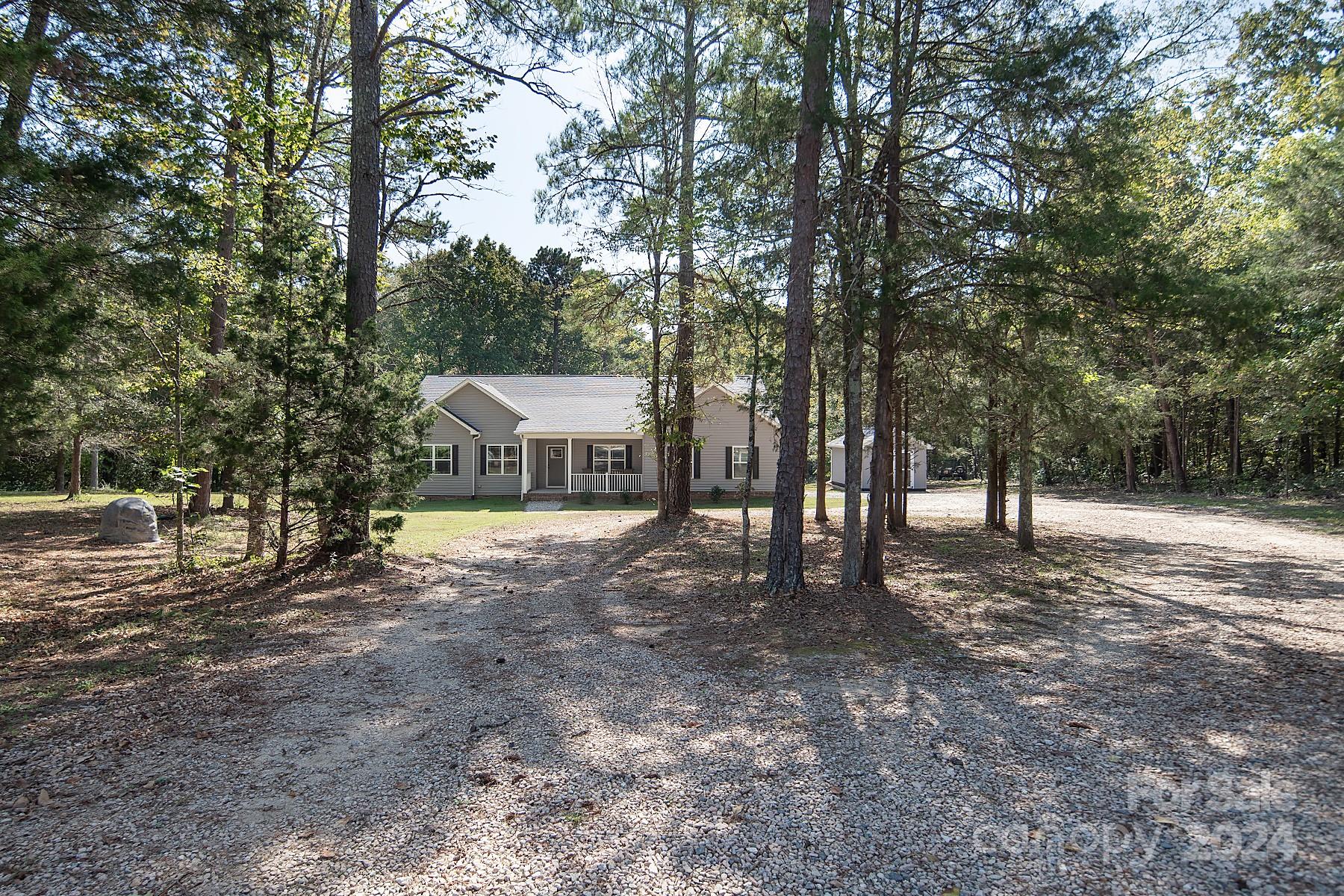 Discover your dream home on 3.13 wooded acres in this charming neighborhood of Concord! This beautifully maintained property features 3 bedrooms and 2.5 baths.  Open concept seamlessly connects the living, dining, and kitchen areas, making it perfect for entertaining and gatherings.  The kitchen has upgraded stainless steel appliances, granite and backsplash. Enjoy cozy evenings by the wood burning fireplace in the living room.  Or step outside on the new extended deck, surrounded by woods for privacy, ideal for relaxation and outdoor entertaining.  Located mins. from town, Carolina Mall, Atrium Hospital, schools, parks, shopping centers, and I-85, this home combines convenience with tranquility. 
Don’t miss your chance to own this gem in Concord! Schedule a showing today and experience all that 3000 Penninger Rd. has to offer. **Home will convey Refrigerator, Water Softener System, 1 Workshop Shed, 1 Storage Shed, 1 Woodshed, 1 John Deer Tractor at zero value. **Agent is the Owner**
