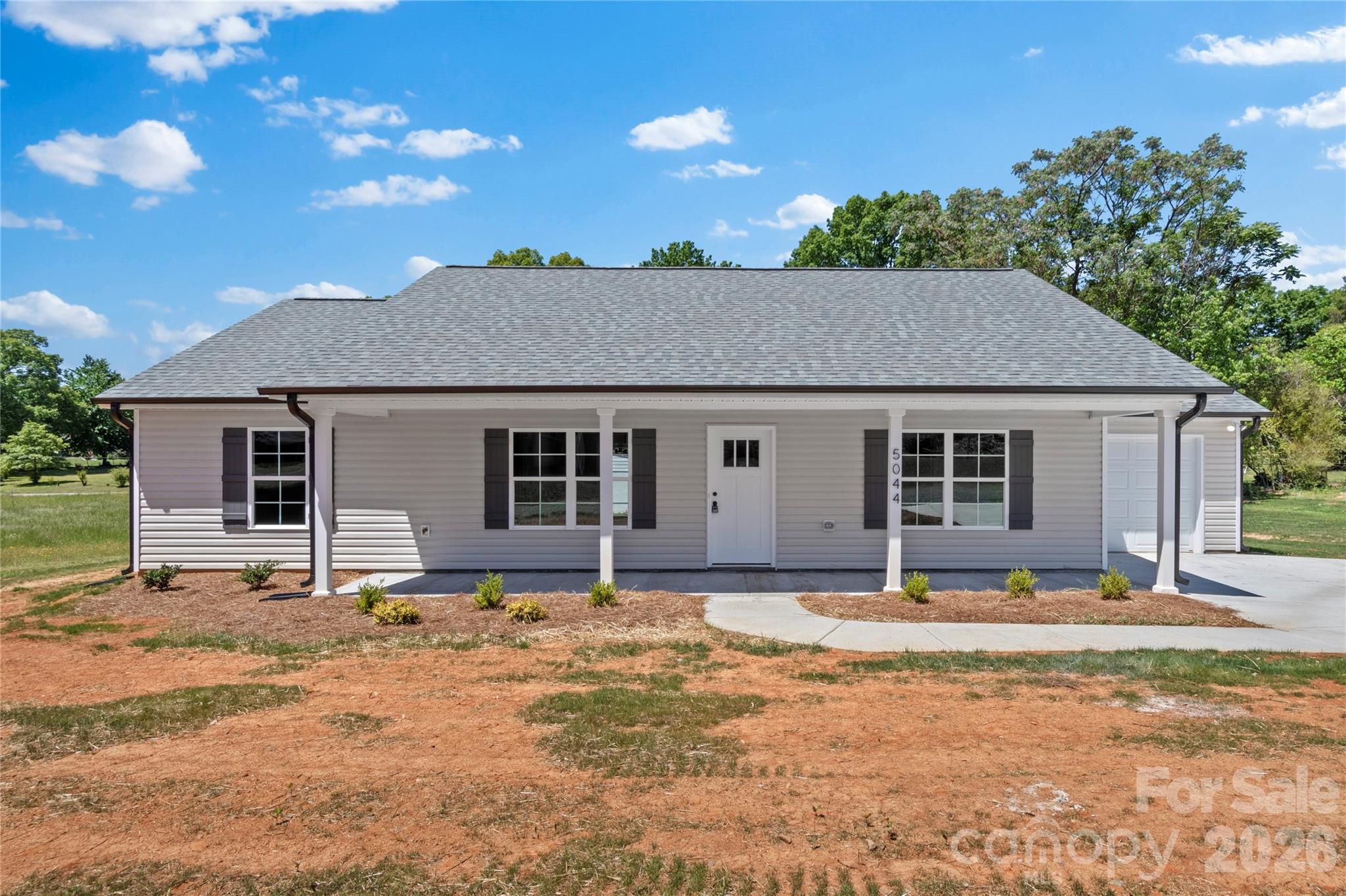 New Construction, 1 Level Home, on almost 1/2 acre ... Covered Front Porch to sit and relax ... Step inside to enjoy the Open Floorplan.. Living Room with Vaulted Ceilings, Ceiling Fan and LVP flooring throughout main living areas.. Dining Area adjacent to Slider Doors to Access Back Patio ... Kitchen with Granite Countertops, Stainless Appliances, Pantry .. Laundry Room adjacent to Kitchen and offers Upper Shelving ... Direct Access to Garage from Laundry Room ... All bedrooms offer carpet .. Primary Bedroom with Walk in Closet .. Primary Bathroom with Single Vanity, Granite Countertops, Walk in Shower, and Linen Closet .... Split Bedroom Floorplan .. Secondary Bath offers Tub/Shower combo ... Smooth Ceilings throughout ... Oversized driveway parking area ... Make this one your new home! (See agent only for OTP instructions)