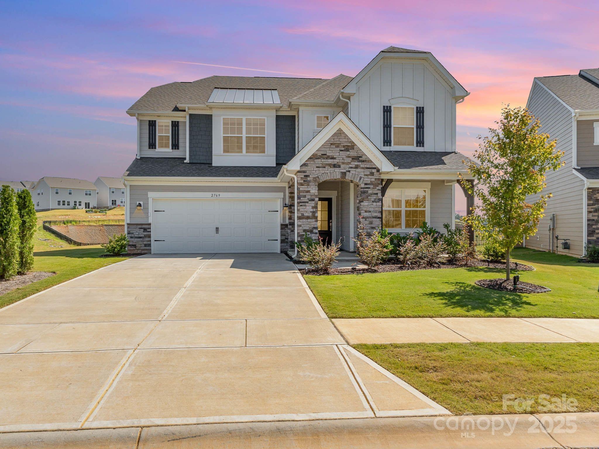 Nestled in the coveted Elizabeth Subdivision of Fort Mill, this 2024-built home exudes a sophisticated blend of modern elegance and meticulously curated design upgrades. Set on a premium lot with breathtaking horizon views, the home benefits from additional privacy with an HOA-maintained lot beside it. Inside, every detail has been thoughtfully enhanced, starting with the gourmet kitchen—equipped with a professional-grade gas cooktop, an oversized farm sink and a striking gold faucet. The formal dining room, graced by an upgraded chandelier and  built-ins for a wet bar, is perfect for hosting elegant dinners, while the expansive living room boasts intricate wall paneling, lighting, and a refined ambiance. A set of French doors leads to a tranquil home office, complete with an upgraded chandelier and wall lighting that adds warmth and sophistication. The home’s staircase, featuring sleek metal rod railings and luxurious LVP steps. Upstairs, the primary suite and four generously-sized bedrooms offer stunning views, with luxurious finishes that elevate each space. Additional highlights include an upgraded vanity in the guest half-bath, epoxy flooring and freshly painted walls in the garage, and a smart home system powered by Google. Blinds and custom window treatments throughout enhance the home’s polished aesthetic. The exterior boasts classic shutters, stone accents, and artful landscaping, with front garden lighting that beautifully illuminates the entry. Future residents will also enjoy the upcoming amenities in the Elizabeth Subdivision: pool and cabana, fitness center, park, playground, pickleball court, trail and bocce ball. With its unparalleled design and premium features, this home is truly a masterpiece—better than new in every sense.