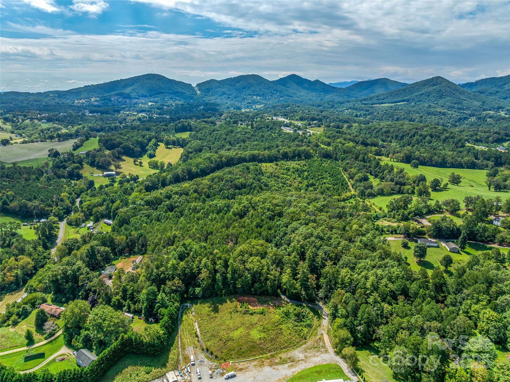 Discover your private mountain oasis just minutes from downtown Asheville. This incredible 12-acre, gently sloping forested hilltop offers privacy and multiple flat building sites, perfect for your dream home. Enjoy peace of mind knowing the property is bordered to the south by a protected land trust. Zoned Open Use with a brand-new working well, and an electrical easement already in place, this property is ready for your vision. Much of the groundwork is done, with soil analysis and septic perk tests completed and multiple sites approved. Located just 7 minutes from Ingles on New Leicester Highway, you'll have excellent year-round access without steep mountain roads. This unique property offers the perfect blend of seclusion, convenience, and natural beauty—an ideal canvas for a custom home, homestead, or multi-generational living.