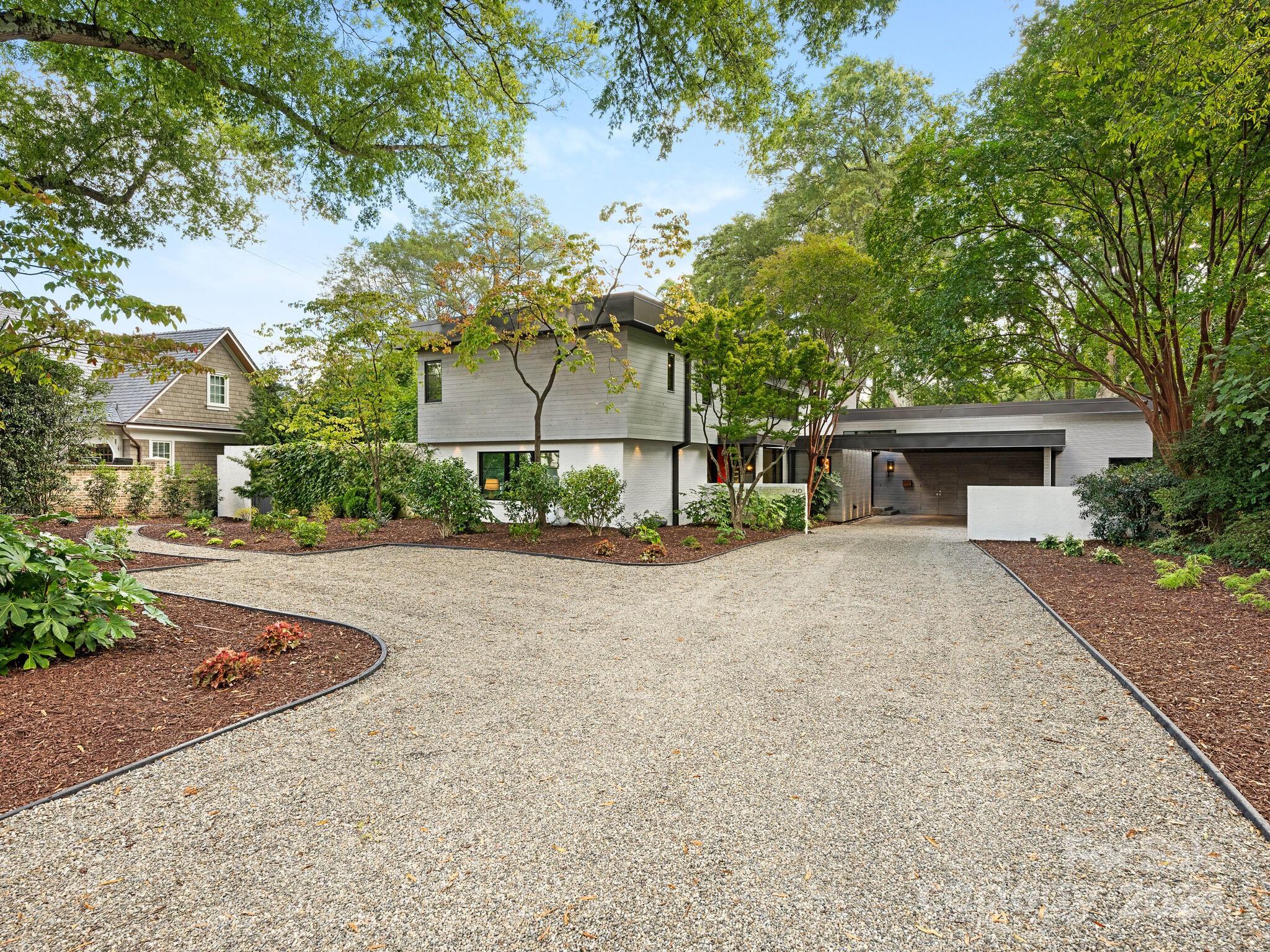 Located in prestigious Eastover, this 2019/20 remodeled/HLA added, Modern, Contemporary, Open Floor Plan Home with floor to ceiling windows on main, brings the outdoors in and is perfect for entertaining.  Hardwoods t-out except wet areas. Master en-suite w/marble floor to ceiling bathroom area w/separate his/her bath vanities, closets, dressing vanity, toilet closet, soaker tub, zero entry shower,(separate room off shower for a sauna or steam room to be added). GR has fireplace and built in computer niche and cabinets. Gourmet Kitchen/Dining and LR/Study all have doors opening to the deck on rear side of home with full glass walls. Shared fireplaces in LR/study w built in bookcases in Study. Laundry and Locker/drop zone on main. Floating glass/oak stairwell goes to upper level with 3 bedroom en-suites and a den.  
Large private landscaped lot w/covered deck in rear w/fireplace overlooking fenced lawn/natural areas.  Attached carport (electric charger outlet) w/ 2 Storage closets.