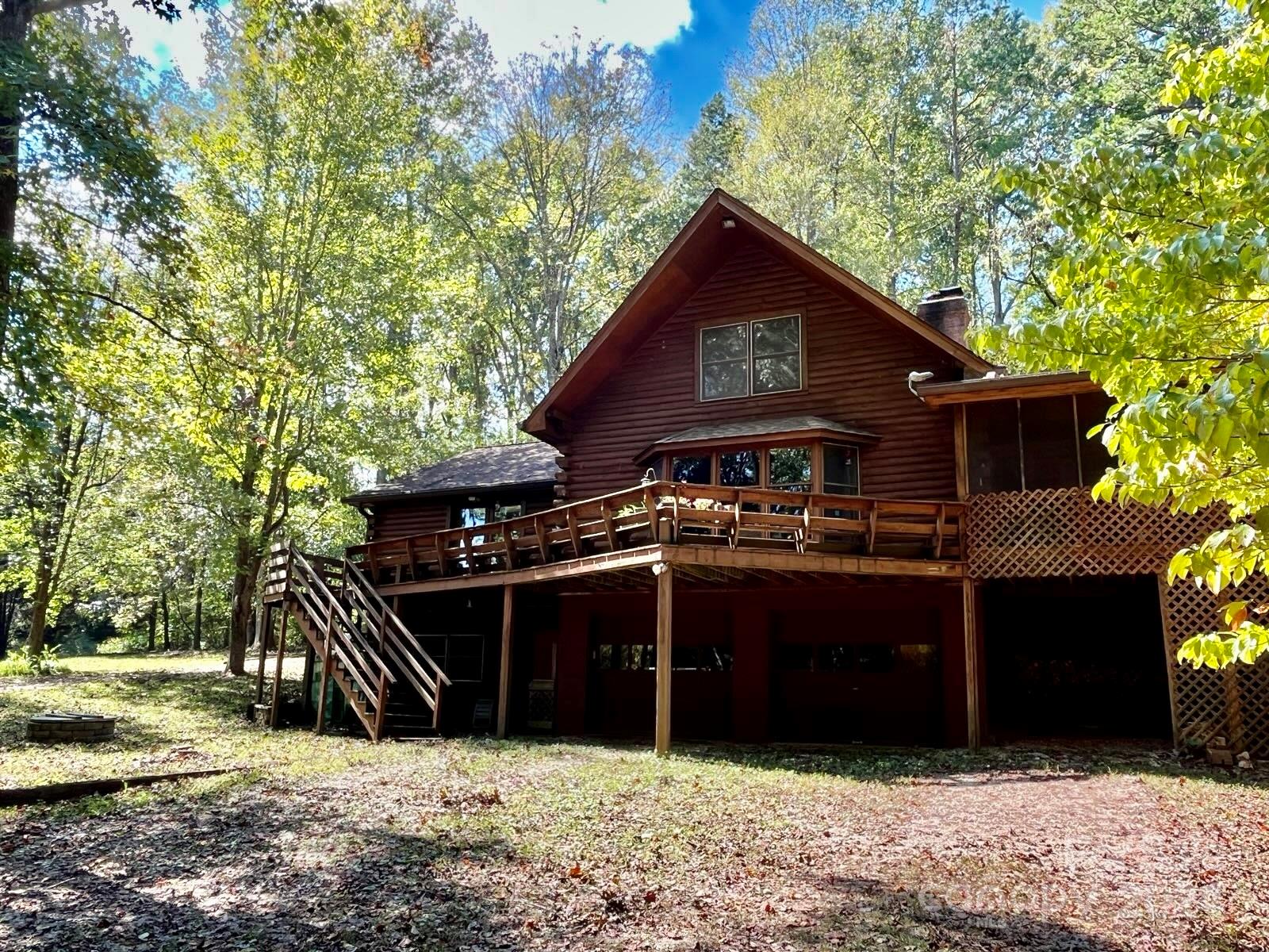 6 Beautiful Acres with a Wonderful Log Cabin Nestled on a Waterfront Lot that includes a Spring Fed Private Lake. 3 Fireplaces, Great Rm w/Cathedral Ceilings, 2nd Floor Loft, Split Bedrm Plan including Spacious Master Bedrm, downstairs Basement Bedrm w/Full Bath & Separate Exit, Potentially makes this a 2nd Living Area or Mother In Law Suite. Basement Workshop. 2 Relaxing Front & Rear Decks as well as 2 relaxing Docks to Fish for Trophy Bass while enjoying the Views. Low Country Taxes ! No HOA ! Horses & certain Farm Animals Welcome. New 50 yr Arch Roof that according to former owner was installed 2007. Leaf Proof Guttering System. Septic pumped July 2024, all looked well according to the service company. Home Security System. Only 40 min to Charlotte Douglas International Airport. Comporium High Speed Internet up to 2 Gbps. Paved County Roads ! All information deemed correct but not guaranteed, please verify anything important, including School assignments before submitting an offer