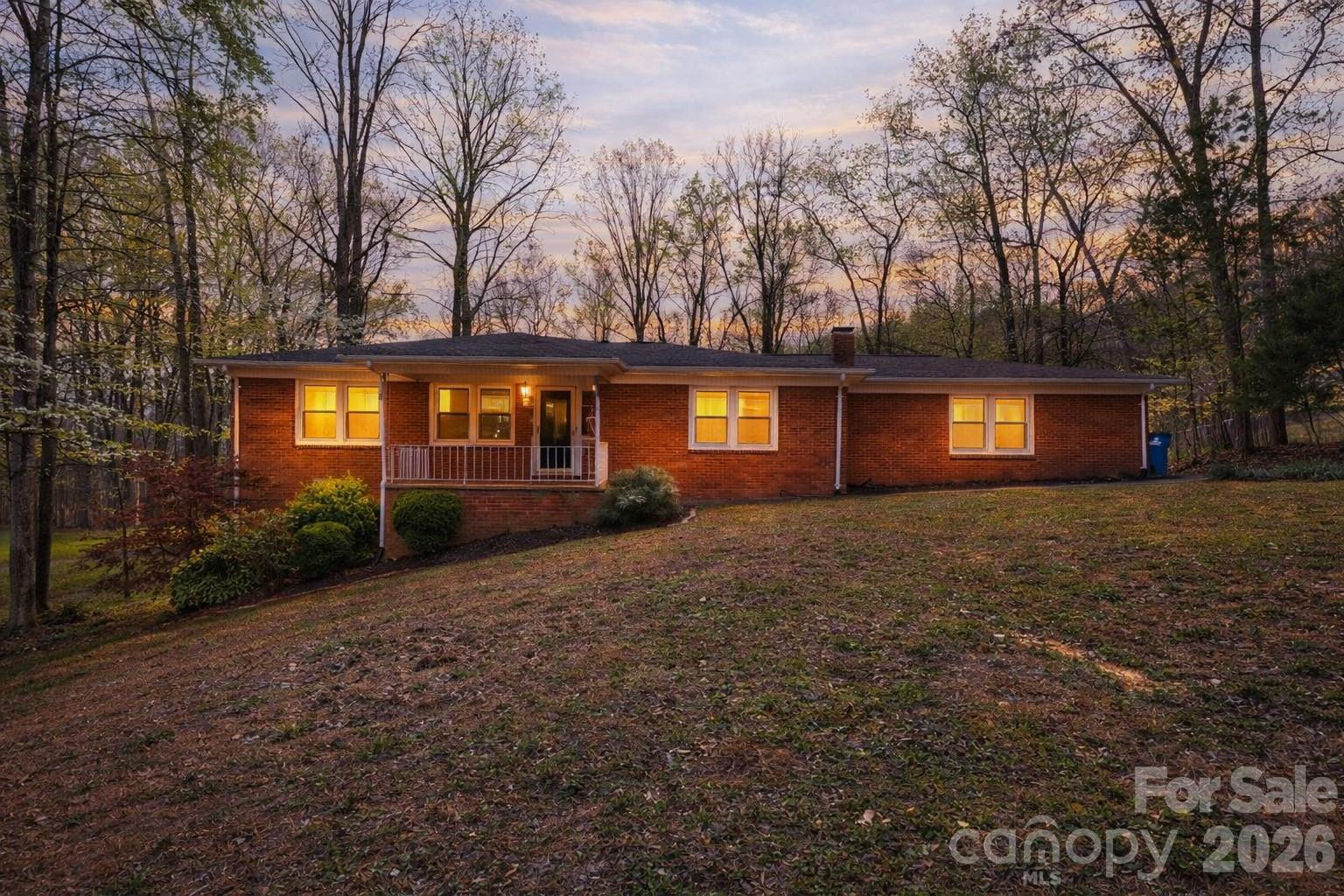 Charming full brick ranch with an open floor plan, spacious great room, and a cozy wood-burning fireplace in the dining area. The primary bedroom features a rare ensuite half bath—hard to find in homes of this era. Unfinished basement with garage provides excellent flexibility. Move-in ready with the opportunity to make it your own. The property needs some cosmetic repairs and is priced accordingly.   Relax on the covered front porch or enjoy the private backyard backing to woods and bordering a creek. Tons of parking and a chicken coop included.  Check out our virtual tour.  Seller is offering a $7500 flooring allowance.