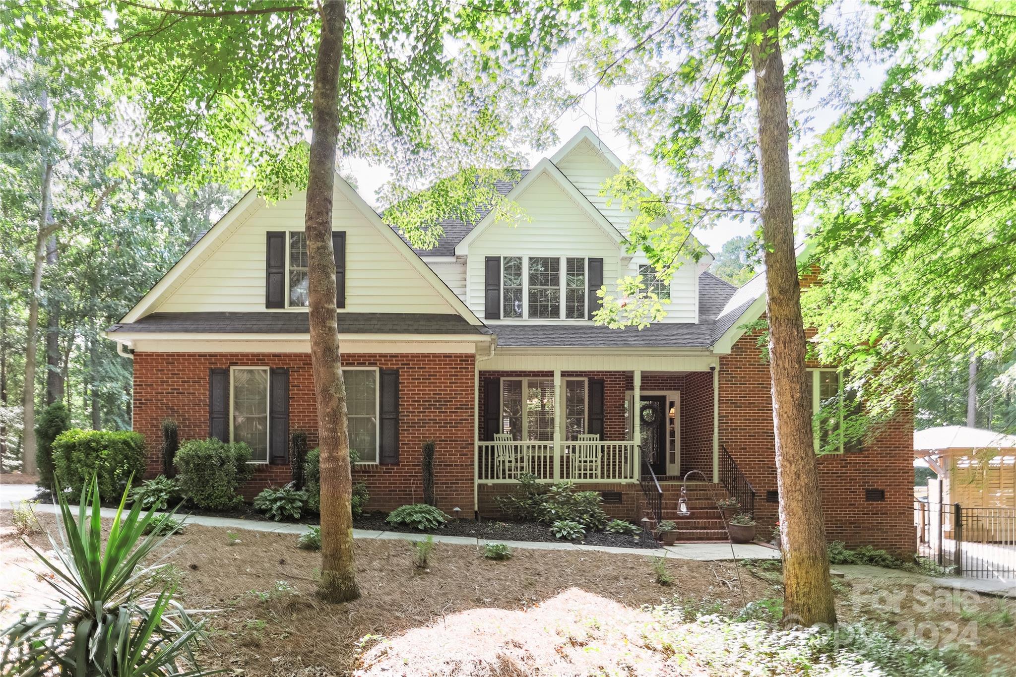 Welcome to your dream home nestled on a 1.55-acre wooded lot offering unparalleled privacy and resort-style amenities. Luxurious custom-built home with a private backyard oasis featuring a heated in-ground pool, outdoor living areas, wet bar, fireplace, wired landscape speakers and extensive lighting. The gourmet, commercial-grade kitchen includes custom cabinetry, quartz countertops, large prep island with built-in wine storage, triple convection ovens, 6-burner gas rangetop with vented out hood and convenient pot filler. The main-level owner’s retreat offers a double tray ceiling, vaulted bathroom with oversized shower, walk-in closet with built-ins and private backyard access. Upstairs, find three additional bedrooms overlooking the two-story great room and foyer. Additional upgrades include hardwood floors throughout main, irrigation system, video surveillance and tankless water heater. Located in the Clover school district and within walking distance to the new Allison Creek Park.