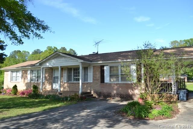 Great brick ranch home that sits on an acre corner lot! Beautiful hardwood floors, newer roof, newer gas pack and gas water heater. This home offers large living room, spacious kitchen and eating area with fireplace. Single carport, side covered patio, wired barn/workshop. This is a must see!  Needs some updating.
