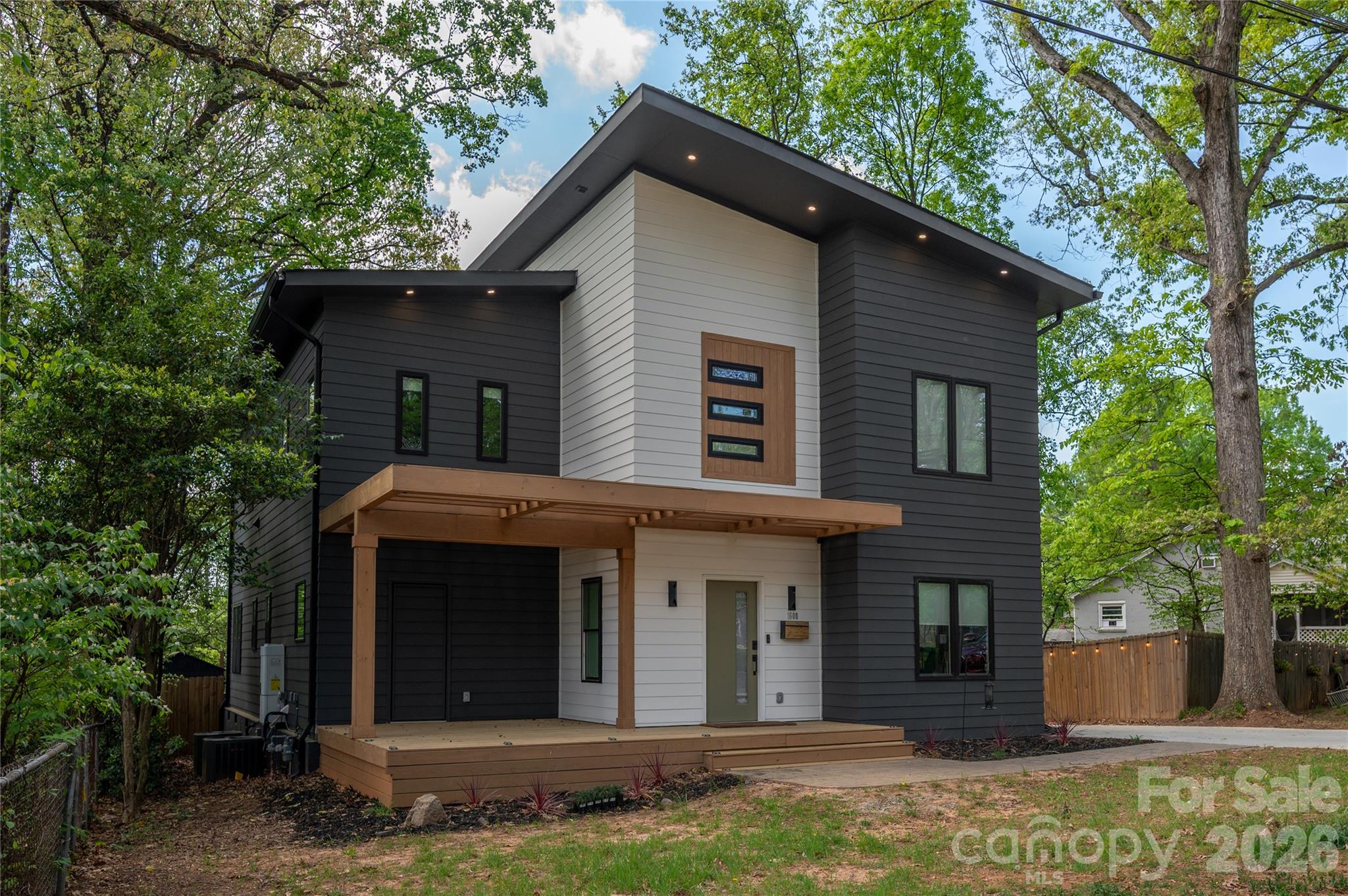 Tucked into the heart of highly sought-after Oakhurst, this striking contemporary home blends modern architecture, thoughtful design, and in-town convenience just minutes from Plaza Midwood, NoDa, and Uptown Charlotte. 

The open-concept main level was designed for both entertaining and daily life, featuring expansive living spaces, oversized windows, and seamless indoor-outdoor flow with front and rear decks. A main-level office or guest suite with full bath adds flexibility for today’s lifestyle.

The kitchen makes a bold statement with sleek flat-panel cabinetry, Calcutta quartz surfaces, a designated coffee bar/ beverage center, generous pantry space, and a large center island overlooking the living and dining areas.

Upstairs, the spacious primary suite feels like a private retreat with a spa-inspired wet room, oversized walk-in closet, and direct access to the laundry room. Two additional bedrooms, a full bath, and well-designed secondary spaces complete the upper level.

Originally rebuilt down to the studs, the home showcases modern systems and design throughout, offering the feel of newer construction in one of Charlotte’s most established and desirable neighborhoods. A rare opportunity to own a truly distinctive property in Oakhurst.
