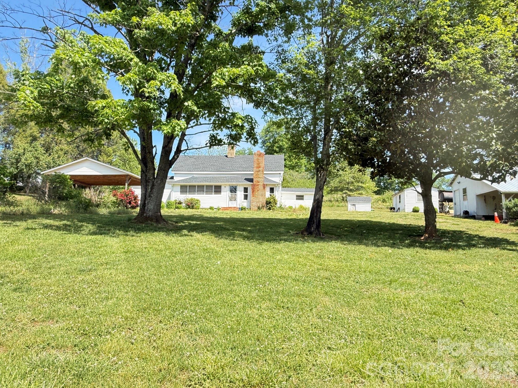 Charming Farmhouse on 1.258 Acres Awaiting Its Transformation!
This delightful home features:
3 bedrooms
1 bathroom
Spacious living room
Functional kitchen and dining area
Come take a look and see how you can make this fit your needs and style!
Nestled in the picturesque foothills of North Carolina, this property is just a short drive from Taylorsville and Wilkesboro.
Home being sold "as-is"
Note:  According to the seller, the shingles on the house, carport, and all other buildings were replaced approximately three years ago. The ceiling height in the living/dining areas and one of the bedrooms is under 7'. There is a monitor oil heater for heat but no ac in the home.  An old well is located inside the utility room of the house and covered with plywood. Property being sold is a portion of a 10+ acre tract and is tract #2 of the plat in photos.