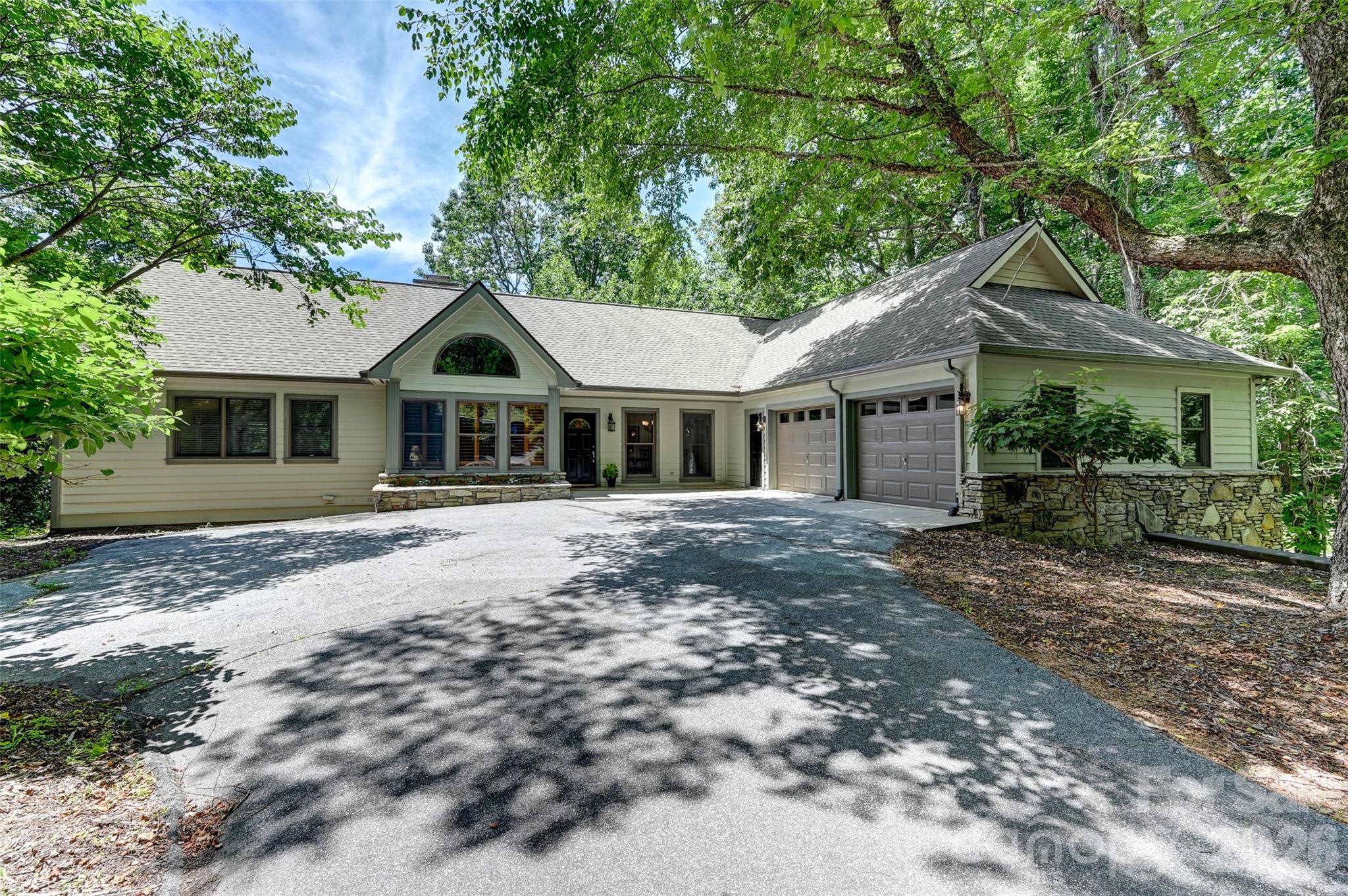 Nestled in the heart of Hendersonville’s prestigious Champion Hills golf community, this exceptional 4-bedroom, 5-bath residence offers the perfect combination of abundant space, convenient location, and refined comfort…109 Chattooga Run is the place with all the space!

With almost 4,000 square feet of living area across two floors, this home was designed to embrace everyday living and elegant entertaining. Whether you’re seeking a tranquil mountain retreat, a golfer’s paradise, or a warm and welcoming place for family and friends to gather, this property has it all.

The main level features a cozy living room and stone fireplace, ideal for both relaxed evenings and lively gatherings. There's also a bright and airy sun room - perfect for enjoying morning coffee or an afternoon book that turns into a well deserved nap. Large Primary suite features walk-in closets, its own rocking porch back deck, and a master bath with large garden tub and shower. Other features include a main level laundry, large two car garage, home office, and a bright, sunny kitchen with a large deck for outdoor evening entertaining and summer dining.

Below, there's plenty of room for those inevitable (and envious) guests, with two large bedrooms and bathrooms, and their own cozy den and fireplace.  For the home hobbyist, there's an additional bonus room and a large 500+ sq. ft. golf cart garage that could double as a workshop, studio, or hobby space for those who need space to create!

Located just a short golf cart drive from the community’s renowned golf club, joining members can enjoy quick access to one of North Carolina’s premier Tom Fazio designed golf courses. Membership unlocks not only golf but also a vibrant club with active social calendar, fitness facilities, new pickle-ball courts, tennis courts, dining , and the opportunity to connect with new neighbors who share a love of the good life.

Located less than 10 miles from Historic Downtown Hendersonville, you'll feel like you live a world away while having convenient access to quality restaurants, shopping, dining and world class healthcare services just around the corner!

Whether you are searching for a full-time residence or a seasonal escape, come see what makes Champion Hills such a special place!