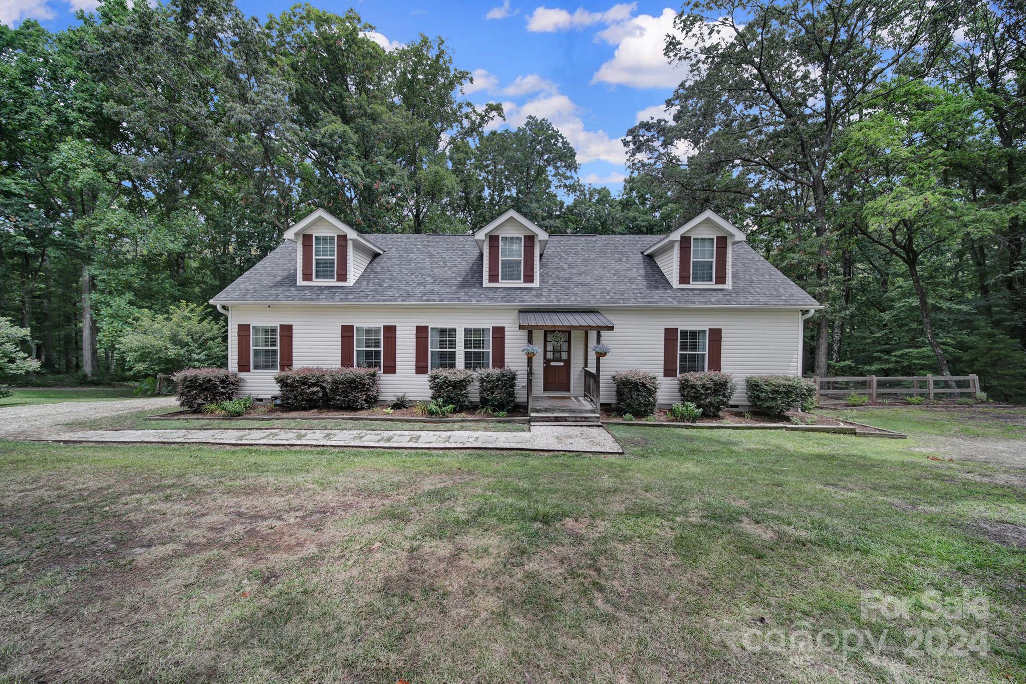 Nestled on a serene 1.3 acre private wooded lot, this charming 3 bedroom, 2 bathroom home offers a tranquil retreat from the bustle of daily life. The property is VERY close to everything while feeling a world away. The wooded lot offers privacy while still giving you plenty of area for a yard or other natural areas. Inside, the spacious living area is open to the eat in area of the oversized kitchen complete w breakfast bar and tons of counter space and cabinets. The master bedroom is very good sized w en suite bathroom complete w extra large garden tub, separate shower, double vanities and built in cabinetry. The other two bedrooms are good sized w plenty of closet space. The unfinished walk up attic is humongous & could be at least two additional rooms plus a bath or an unbelievable bonus room, but it's also great as easy to access storage. The extra large deck overlooks the fenced backyard complete w wired workshop. Very desirable home & property near everything Rock Hill offers!!