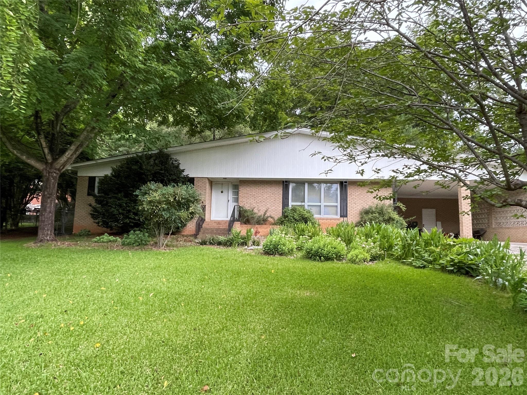 Welcome home to this charming one-level brick residence offering timeless appeal and endless potential. Inside, you'll find a spacious living room filled with natural light from a large picture window, along with a cozy family room featuring a classic brick fireplace that's open to the kitchen—creating a comfortable space for everyday living and entertaining. The fenced backyard provides privacy and room for pets, play, or gardening. While the home retains some of its original finishes, it offers a solid foundation, a desirable layout, and the opportunity to make it your own. Whether you're looking for move-in ready or someone wanting to add your personal touch, this home is full of possibilities. With its mid-century modern vibe, you won't want to miss out on this one!
