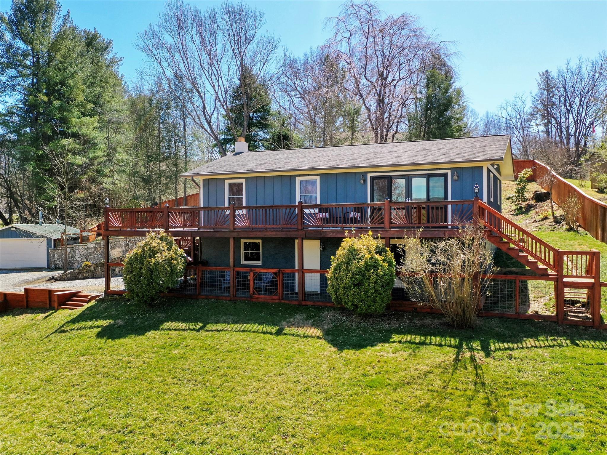 This gorgeous home offers the perfect blend of space, serenity, and functionality. With panoramic mountain views that will take your breath away, you'll feel like you're living in your own private retreat. The expansive layout includes a full basement featuring a dedicated workshop, exercise room, laundry area, with walk out access to enjoy your hot tub after a long day. The open floor plan allows for seamless indoor-outdoor living, with a large wrap-around deck ideal for enjoying the surrounding nature and fresh air. The generous backyard is fully fenced, offering both privacy and space for outdoor activities, gardening, or entertaining. As an added bonus, this property includes a spacious 1022 sq ft metal building heated with wood stove, providing endless possibilities for a studio, additional workspace, or even a hobbyist's dream. Whether you're seeking peaceful solitude, room for hobbies, or a place to host friends and family, this home has it all.
