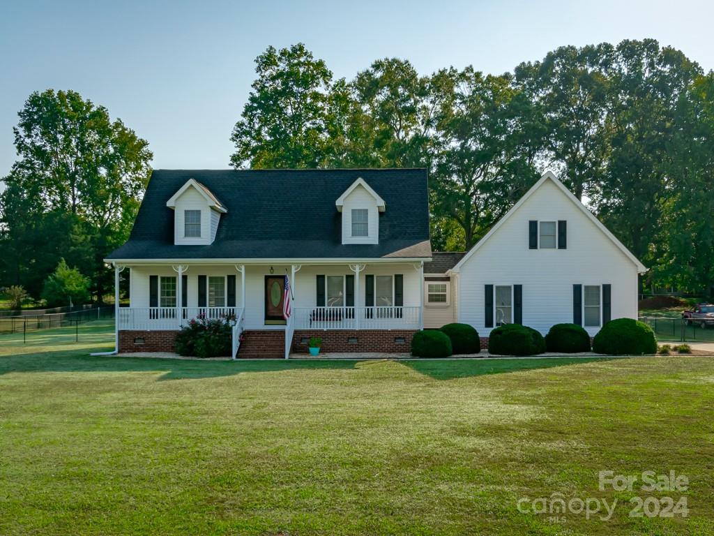 ****RARE FIND**** Southern Charmer On Over 1 Acre with rocking chair front porch!  Spacious primary suite on main level.   Cozy living room with corner fireplace.  Two Large bedrooms up.   From the two car attached garage you will find stairs leading up to a separate suite/4th bedroom complete with a chimenea gas fireplace, a full bath, walk in closet and murphy bed

The exterior of the home features a deck overlooking the above ground pool, fenced yard and building.  The building/shop is wired and has a separate entrance with ramp for your mower.  Cul-de-sac street.

**4th bedroom and full bath not counted in heated living area***