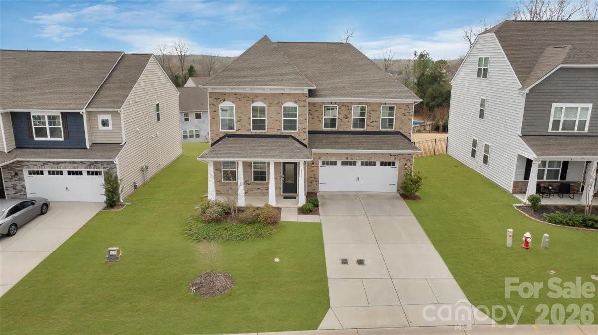 For sale is a single-family detached home located in the highly sought-after Cuthbertson School District in Waxhaw. This NORTHEAST-facing home is situated in the desirable Cortona community and features one of the most popular floor plans, offering a spacious and functional layout ideal for modern living. The main level boasts a large family room that opens seamlessly to a well-appointed kitchen with a breakfast nook and a formal dining area—perfect for everyday living and entertaining. The home offers 5 bedrooms and 4.5 bathrooms, including a convenient main-level guest suite with a private bath. Upstairs, a generous loft provides flexible space for a media room, home office, or play area. Residents enjoy access to planned neighborhood amenities, including a clubhouse, fitness center, outdoor entertaining areas, bocce, and horseshoe courts. An excellent opportunity to own in one of Waxhaw’s most desirable communities with top-rated schools.
