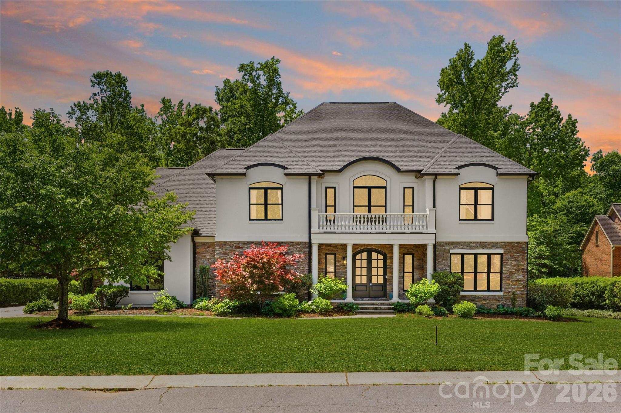 Welcome to 1025 Sherringham Way in The Gardens on Providence, a quiet custom community in the heart of Weddington, NC, perfectly positioned between Charlotte and Waxhaw with convenient access to I-485 and located in the highly sought-after Marvin School District.
Life here feels different.
Mornings begin with sunlight pouring into the screened porch as you sip coffee overlooking your completely private backyard retreat. The home backs to an exclusive 330-acre private compound, creating a rare sense of space and seclusion that is almost impossible to find this close to South Charlotte.
Built in 2005 and offering nearly 5,400 square feet, this traditional residence blends timeless architecture with warm and welcoming luxury. High ceilings, custom trim and molding, and hardwood floors throughout the main living areas create an elevated yet comfortable atmosphere.
At the center of the home, the chef’s kitchen invites gathering. An oversized island with prep sink anchors the space, complemented by a Viking gas range, Thermador oven, and abundant cabinetry. The kitchen flows seamlessly into the main living areas, making entertaining effortless and everyday living easy.
The primary suite on the main level is a private sanctuary overlooking the pool. Tray ceilings add architectural depth, while the spa-like bath features a garden tub, frameless shower with foot washing feature, and a spacious walk-in closet.
Upstairs, generous secondary bedrooms, a finished bonus room, and a sixth bedroom that can function as a gym, flex space, or additional recreation room provide flexibility.
Step outside and experience what truly sets this home apart. The fenced backyard offers a pool bathed in morning sun, complete privacy with no rear-facing neighbors, neighbors on either side cannot see into backyard, and peaceful wooded views. Evenings here feel slow and restorative, whether gathered by the pool or relaxing on the screened porch beneath the wood ceiling.
Additional features include a three-car garage, central vacuum system, irrigation, and access to neighborhood amenities including tennis courts and a community pond. The entire community sits on a cul-de-sac street, eliminating thru traffic and enhancing the sense of quiet.
This is more than a home. It is privacy, connection, and convenience wrapped into one exceptional Weddington address.