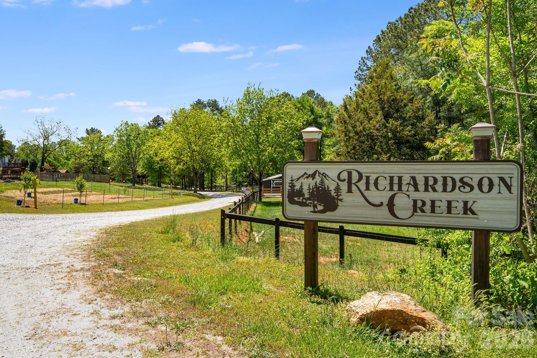 Discover the perfect blend of tranquility and accessibility on this beautiful 2.04-acre creek-front lot. Located in the peaceful Richardson Creek community, this mostly forested property offers privacy and 350 feet of direct frontage on Richardson Creek. The gentle, level terrain provides multiple ideal footprints for your custom home, and with a well already in place, you are one step closer to breaking ground on your dream retreat. Enjoy well-maintained gravel roads and a quiet neighborhood atmosphere that feels worlds away, yet remains perfectly positioned: just 20 minutes to Rutherfordton, 30 minutes to the Tryon International Equestrian Center, and a little over an hour to the vibrant hubs of Asheville and Charlotte. Your private woodland escape is ready for its next chapter.