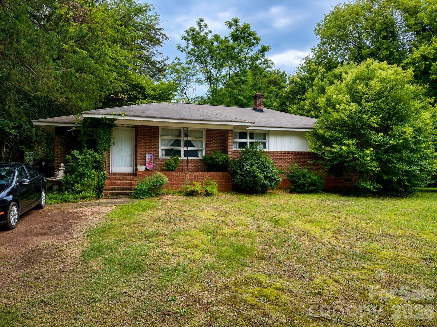 Charming brick home situated on a spacious corner lot in Charlotte. This 3 bedroom, 1 bath home features hardwood floors, spacious rooms, an enclosed porch offering flexible additional space, and an attached utility room for storage and laundry. With much of its original character still intact, the home offers a wonderful opportunity to update and personalize to your taste. The HVAC system was installed in 2014. Conveniently located near I-77, providing easy access to Uptown Charlotte, the airport, shopping, dining, and surrounding areas.