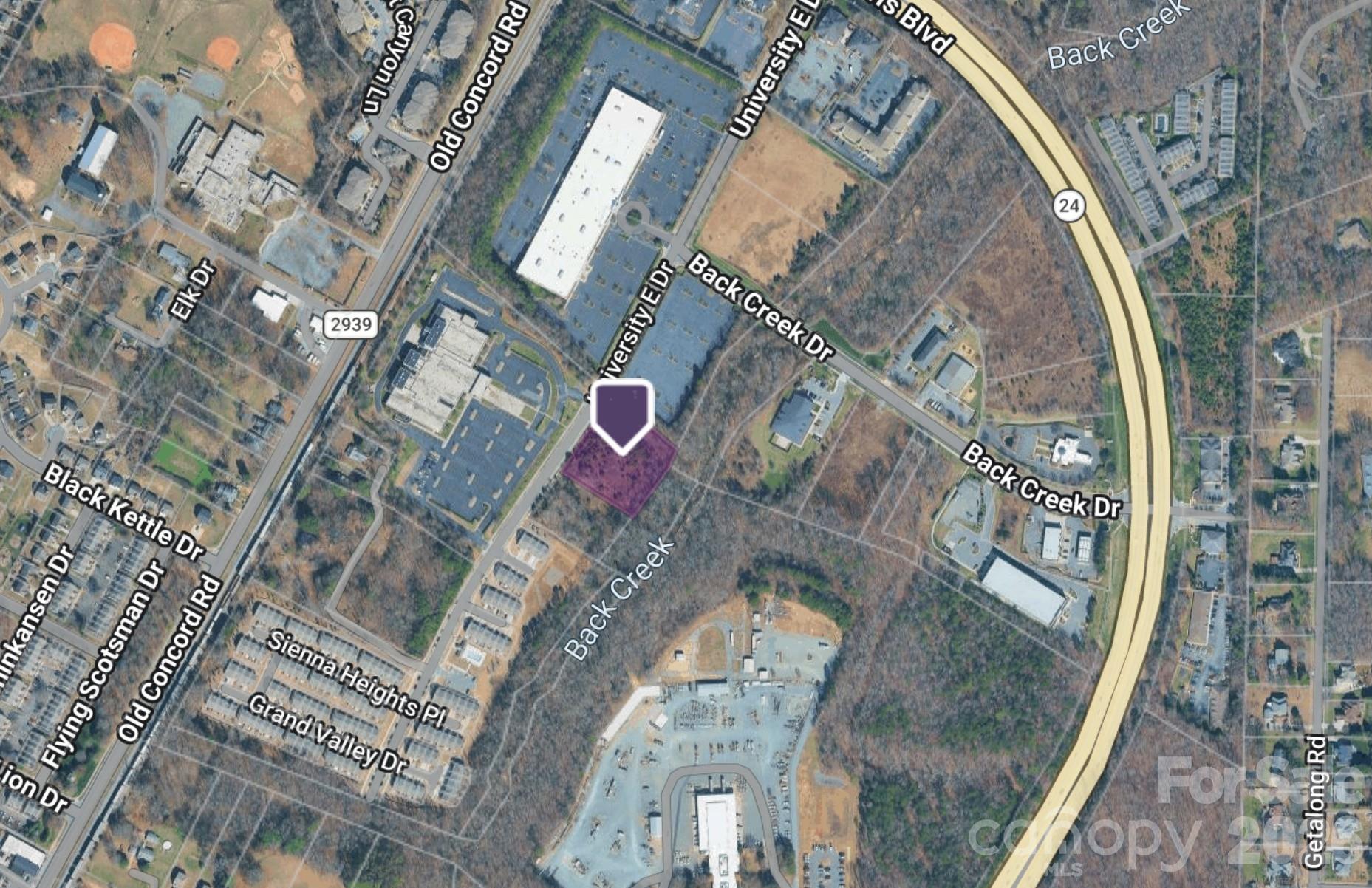 University East & Old Concord 1.672 Acre Development Opportunity
Charlotte, North Carolina

Located at the intersection of University East Drive and Old Concord Road, this 1.672-acre site presents a compelling development opportunity in one of Charlotte’s most active growth corridors—University City.

Positioned just off W.T. Harris Boulevard, a major east–west arterial, the property benefits from strong connectivity, high visibility, and immediate access to the broader North Charlotte market. The surrounding area features a diverse mix of uses, including attached single-family residential, multifamily communities, retail centers, hospitality, medical office, and established suburban office parks—creating a well-rounded live-work-play environment.

The site offers meaningful optionality for developers, with the ability to accommodate a range of product types including:

Multifamily or build-to-rent residential
Townhome or attached single-family
Mixed-use or neighborhood-serving retail
Medical or professional office
University City continues to see significant momentum driven by:

Ongoing expansion and investment at University of North Carolina at Charlotte
Strong job growth across North Charlotte, including major employers like Albemarle Corporation and Eli Lilly and Company
Continued residential and retail development supporting population growth and demand
With its strategic location, surrounding density, and proximity to employment and institutional anchors, University East & Old Concord represents a well-positioned infill development opportunity within a rapidly evolving submarket.