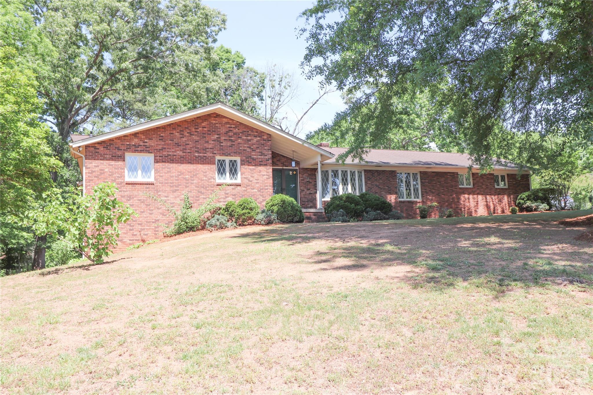 Charming 3-bedroom, 3-bath brick home situated on 1.3 acres in Valdese, NC. The spacious living room opens to an enclosed back porch that overlooks a generous backyard—perfect for relaxing or entertaining. A convenient two-car attached garage leads directly into the kitchen, making everyday tasks like unloading groceries a breeze.
The front family room offers lovely views of the expansive front yard and mature shade trees. A formal dining room provides additional space for hosting gatherings and special occasions.
The finished basement features a large recreation room with a fireplace, along with a full bath and laundry area. An expansive unfinished section, accessible via a garage door, offers excellent potential for a workshop, storage, or lawn equipment.
Major updates include a heat pump and furnace installed in 2022.