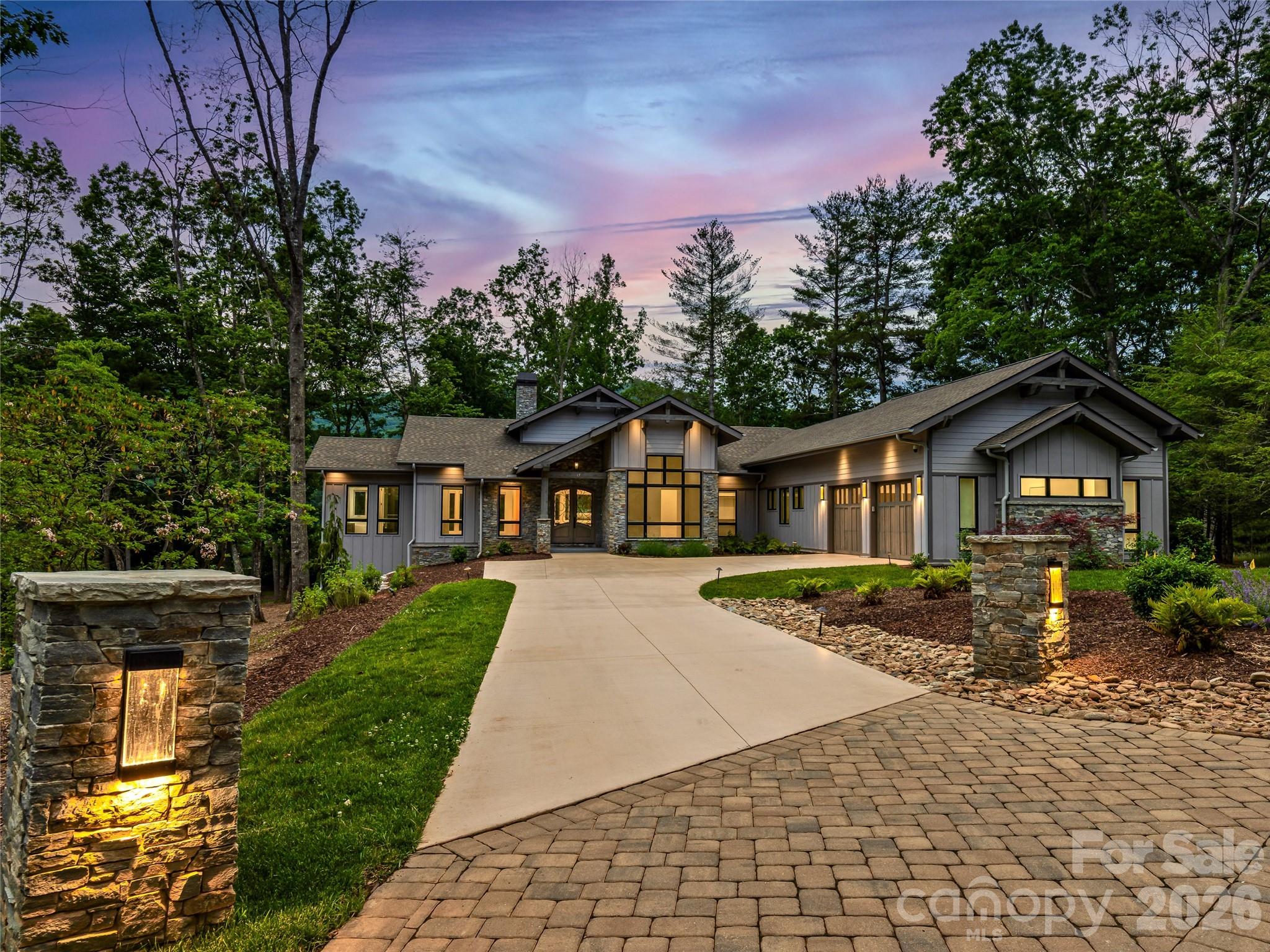 This stunning custom-built residence located within The Cliffs at Walnut Cove offers refined single-level living with a seamless connection to the outdoors. Thoughtfully designed, this home showcases a light-filled interior with expansive windows and clean architectural lines. Spanning more than 3000 square feet, the home features 4 bedrooms, 3 full baths, and a powder room, with a flowing layout ideal for both everyday living and entertaining.

Outdoor living takes center stage with an elevated deck overlooking a stunning resort-style saltwater pool, expansive stone terrace, and fire pit lounge—creating a true private oasis surrounded by a wooded backdrop. This property offers a serene retreat within one of the most sought-after gated communities, with access to premier amenities, a Jack Nicklaus Signature golf course and exceptional access to local shopping and dining.