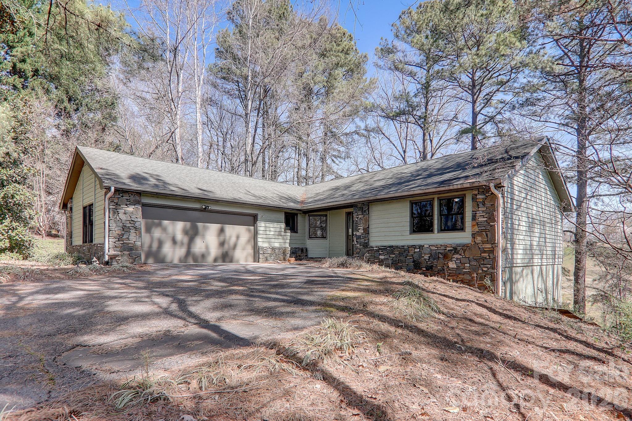 Tucked within the scenic Rumbling Bald community of Lake Lure - a peaceful retreat with easy access and fully operational utilities—untouched by Hurricane Helene. Set on a .59-acre lot overlooking the 10th hole of the Apple Valley golf course, this inviting home captures the essence of resort-style living. Enjoy the ease of one-level living with all three bedrooms and two full bathrooms thoughtfully located on the main floor. The spacious kitchen—also on the main level—opens seamlessly to a generous deck, ideal for outdoor dining or relaxing in the mountain air. A second deck on the lower level provides additional space for entertaining or quiet enjoyment of the serene surroundings. Inside, you’ll find updated tile and vinyl plank flooring throughout, freshly painted interiors, and modern light fixtures that add warmth and character. The attached garage enhances daily convenience, while nearby community amenities—including an outdoor pool—further elevate the lifestyle. Owner is broker.