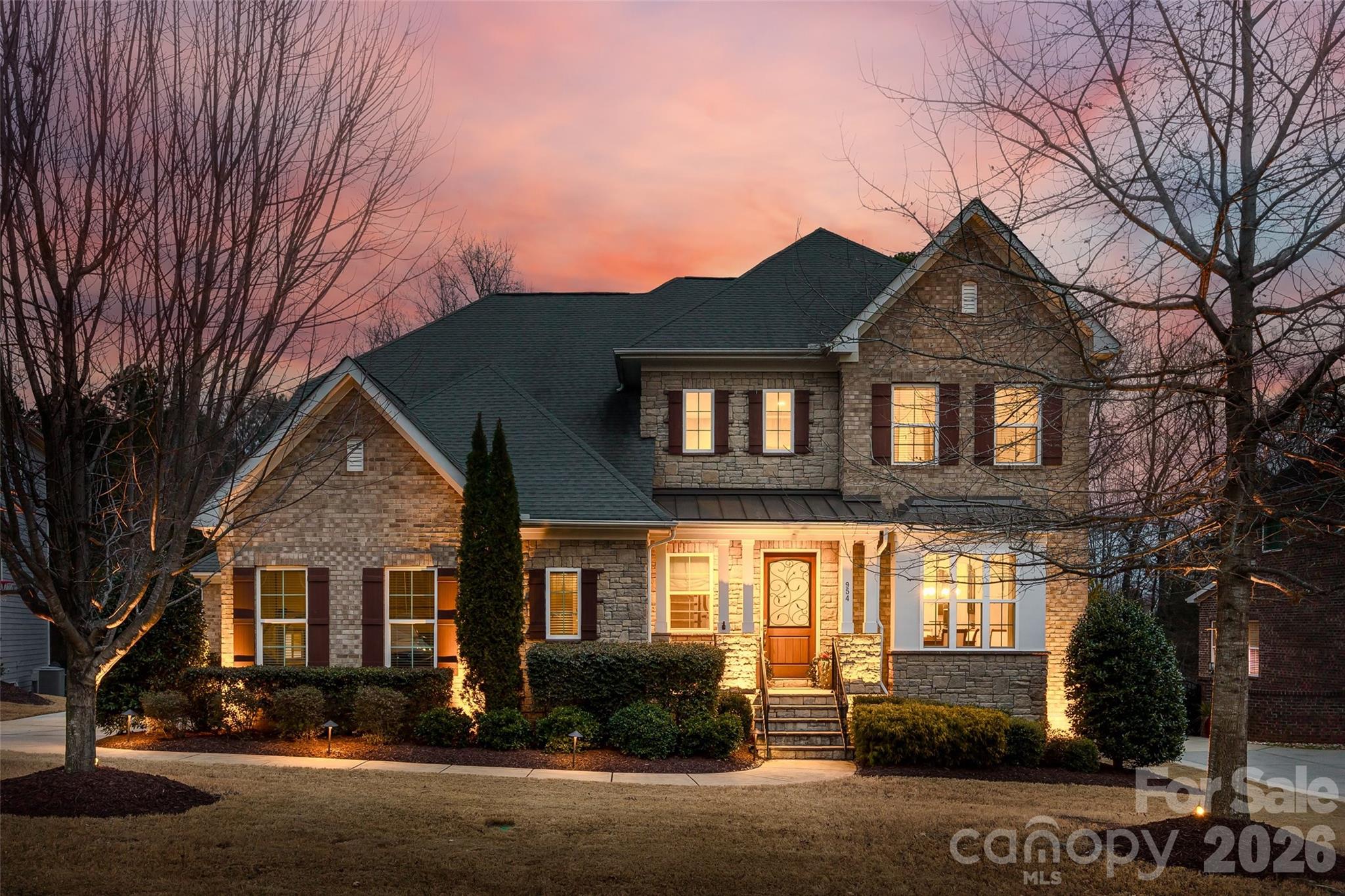 Stately full brick home with stone accents nestled on a quiet cul de sac street in highly sought after Eppington South. An elegant iron grill wood door at the entrance welcomes you home. An open floor plan with beautiful gleaming wood flooring and neutral paint throughout the main living areas. An abundance of windows allowing natural light radiates throughout the home, and the rounded doorways giving it a warm inviting cozy feel. The soaring two-story foyer features a stunning lighting fixture, decorative molding and a grand staircase creating a striking first impression of the home. The foyer opens to the dining room accented with a lovely coffered ceiling and decorative molding. Spacious great room with corner gas fireplace and ample windows with picturesque views of the backyard. The great room opens to the kitchen with a lovely rounded archway.The kitchen is a chef's dream - huge oversized island with decorative beadboard accents, ample seating and upgraded pendant lights, gas stove with hood, double oven, soft close kitchen cabinets & drawers, stacked cabinets accented with in-cabinet lighting. The butler's pantry, conveniently located within reach of the walk in pantry is equipped with plenty of cabinets and counter space for entertaining. The breakfast area - perfect for casual modern-day living completes the kitchen. Main level bedroom and full bath is perfect for guests or home office. Follow the sweeping staircase to the 1st landing, where you will find a huge bonus/rec room with plenty of storage. The 2nd landing leads to the private oversized primary ensuite featuring a coffered ceiling, walk in closet, dual vanities with granite counter tops, garden tub, tiled shower and separate water closet. Down the hall is a bedroom ensuite and 2 additional secondary bedrooms with a jack & jill bath, a convenient 2nd level laundry room with a utility sink. The outdoor living spaces create a seamless and relaxing private outdoor oasis.  An inviting screened porch with skylights provide the perfect spot for morning coffee, afternoon reading or evening conversations. Beyond the porch is an expansive two-tiered patio. The upper level is perfect for grilling and alfresco dining. A few steps down is the perfect gathering spot centered around the built in firepit. Surrounding the firepit is a seating wall providing an open and welcoming feel. Tucked away under the porch are 2 hammock swings- the perfect spot for relaxing in your backyard oasis.  As the day fades, the outdoor lighting transforms the patio space into glowing retreat.  The yard has been lovingly manicured and perfected. It unfolds in beautiful succession as the year evolves. Close to I-77, restaurants, medical and shopping. It's more than a home- it's a lifestyle where timeless luxury meets private sanctuary.