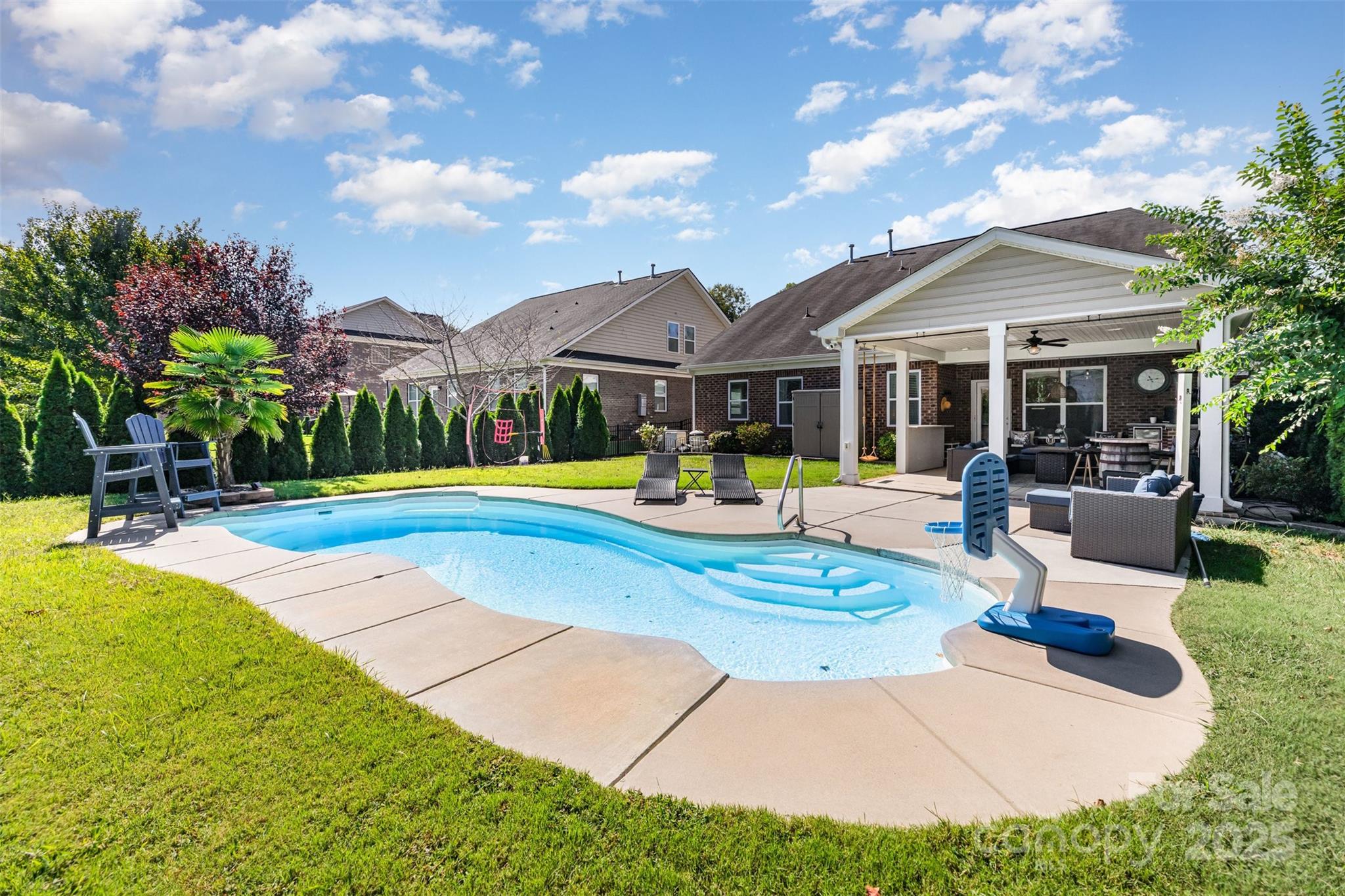 Back on Market to no fault of seller!
Entertainer’s dream in award-winning Clover schools! This full-brick 4-bedroom, 3-bath home lives easy with the Primary suite on the main level plus a second main-level bedroom with its own full bath—ideal for guests, an office, or multigenerational living. Second level boasts two additional bedrooms, a full bath, and a spacious family room m for play, workouts, relaxing or media. Smart-home upgrades include Alexa-linked dual-zone thermostats, Ring doorbell, and front and rear security spotlights. Fresh updated lighting, fans, and interior paint deliver a crisp, move-in-ready feel. Outside, your private oasis awaits: a 14,000-gallon heated saltwater pool, plus a built-in grill area, beverage cooler, and TV under the extended covered 464 square foot patio built in 2022—perfect for game day or summer nights. The flat, fenced yard is wrapped in privacy trees and enhanced by dusk-to-dawn landscape lighting. All of this in the heart of Clover—minutes to the lake and parks, about 30 minutes to Charlotte Douglas International Airport, with low South Carolina taxes. Come home to resort-style living, everyday.
