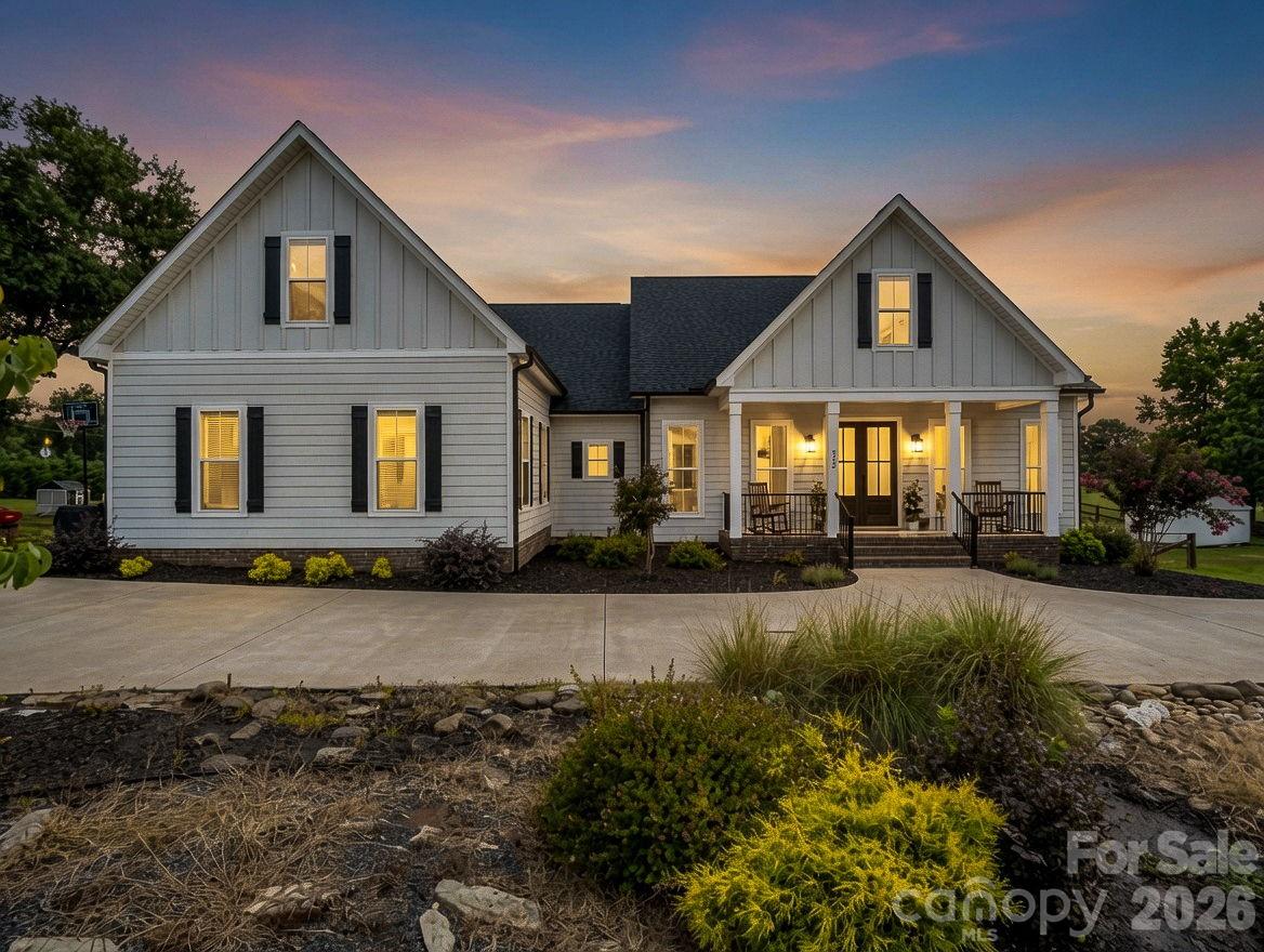 Welcome home to a perfect blend of modern luxury and farmhouse charm. You will notice the custom details from the moment you pull into the circular drive. You'll be greeted by a great room with a large stone fireplace extending to the cathedral ceiling with exposed beams. The kitchen features a commercial-grade Kucht gas range, wall oven, island bar, and a spacious walk-in pantry. Just off the kitchen, you will find a bright sunroom that can double as additional dining space overlooking the backyard and surrounding pasture. The large primary bedroom connects to a roomy en-suite bathroom with a soaking tub, walk-in shower, dual vanities, and a walk-in closet. The split floor plan features two additional guest bedrooms on the main level and another full bathroom with a walk-in shower. Also on the main level, you will find a cozy den/office area with a tiled floor leading out to the large 500+ sq. ft. attached garage. Upstairs offers great opportunity as a second living quarters with tons of space, a full bathroom, walk-in closet, and additional cabinet space with a sink. At over 3,000 sq. ft. and sitting on nearly an acre of land with a partially fenced backyard for pets, this home has almost everything. Best of all, it is located just minutes from Highway 74, Downtown Forest City, and the Tryon International Equestrian Center.