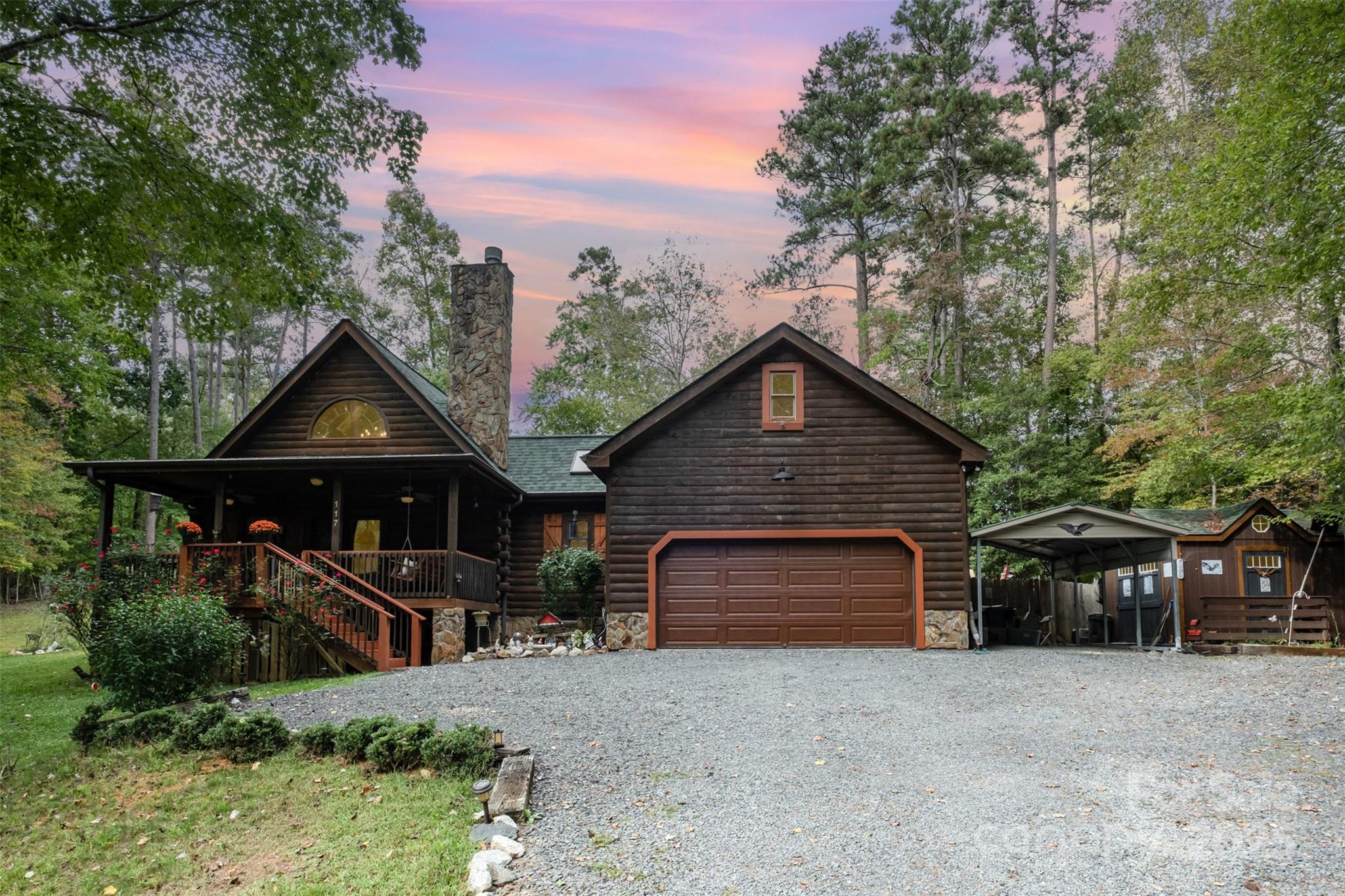 Reconnect with nature in this beautiful log cabin retreat on Lake Tillery. Nestled within the serene, gated community of Woodrun, this beautifully maintained log cabin offers the perfect blend of rustic charm, modern comfort, and peaceful outdoor living. Set on a wooded lot with fruit trees and space to garden, this home invites you to slow down and truly enjoy nature.  Inside, you’ll find two bedrooms on the main level—one with its own ensuite—and a spacious upper-level retreat featuring a large bedroom with loft, private balcony, and ensuite bath.  The sunroom/den area is perfect for enjoying views of the changing seasons, while the covered front and back porches invite you to relax in a rocking chair.  Make this home your own by converting the unfinished basement into additional living space or use for additional storage. There is also a large, floored attic space over the garage with pull down stairs, perfect for additional living space and storage. 

Enjoy access to: hiking trails through natural landscapes, community clubhouse with scheduled social events, tennis, pickleball, basketball courts, swimming pool with spectacular lake views, boat and kayak launches and storage areas.  Located just minutes from the Uwharrie National Forest, outdoor adventures like hiking, mountain biking, and exploring the lake are always within reach. Whether you're looking for a weekend escape or a peaceful full-time home, this is a place where you can truly connect—with nature, neighbors, and a slower pace of life.

(PLEASE NOTE: GATED COMMUNITY - ACCESS WITH AGENT ONLY!)
**Key Updates: Exterior Stain (2024), Roof (2021), Water Heater (2025)
**Items not conveying: front porch swing, drapery, curtain rods, flag pole, refrigerator. Sellers plan to take carport & storage building but are open to offers.