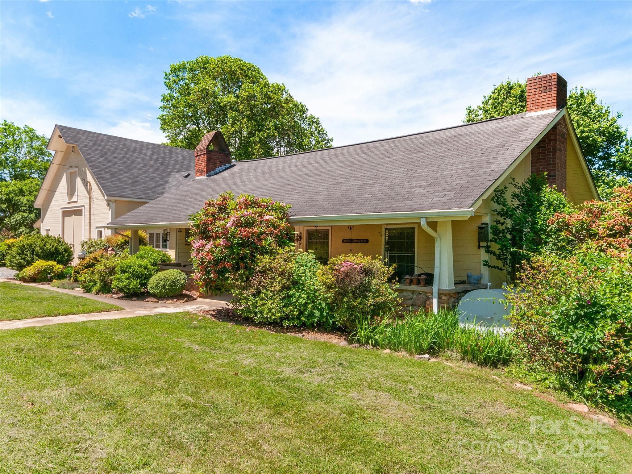 BACK ON THE MARKET! NO FAULT OF THE SELLERS!! This 1930-built, 2,294 sq ft home on over 3 acres captivates with its breathtaking long-range mountain views, a feature that defines its charm and sets it apart. Nestled in a serene landscape, the property blends historic character with modern updates, including a recent addition, a two-zone HVAC system, and an updated roof. The sprawling 3*-bedroom 2-bath layout boasts a huge primary suite with a Juliette deck, a great room with vaulted ceilings and exposed beams, and a formal living room with built-ins and a fireplace. A double car garage in the basement, a 600 sq ft workshop, and a private well enhance functionality, while the covered front porch and rear deck invite you to soak in the stunning vistas that make this home unforgettable