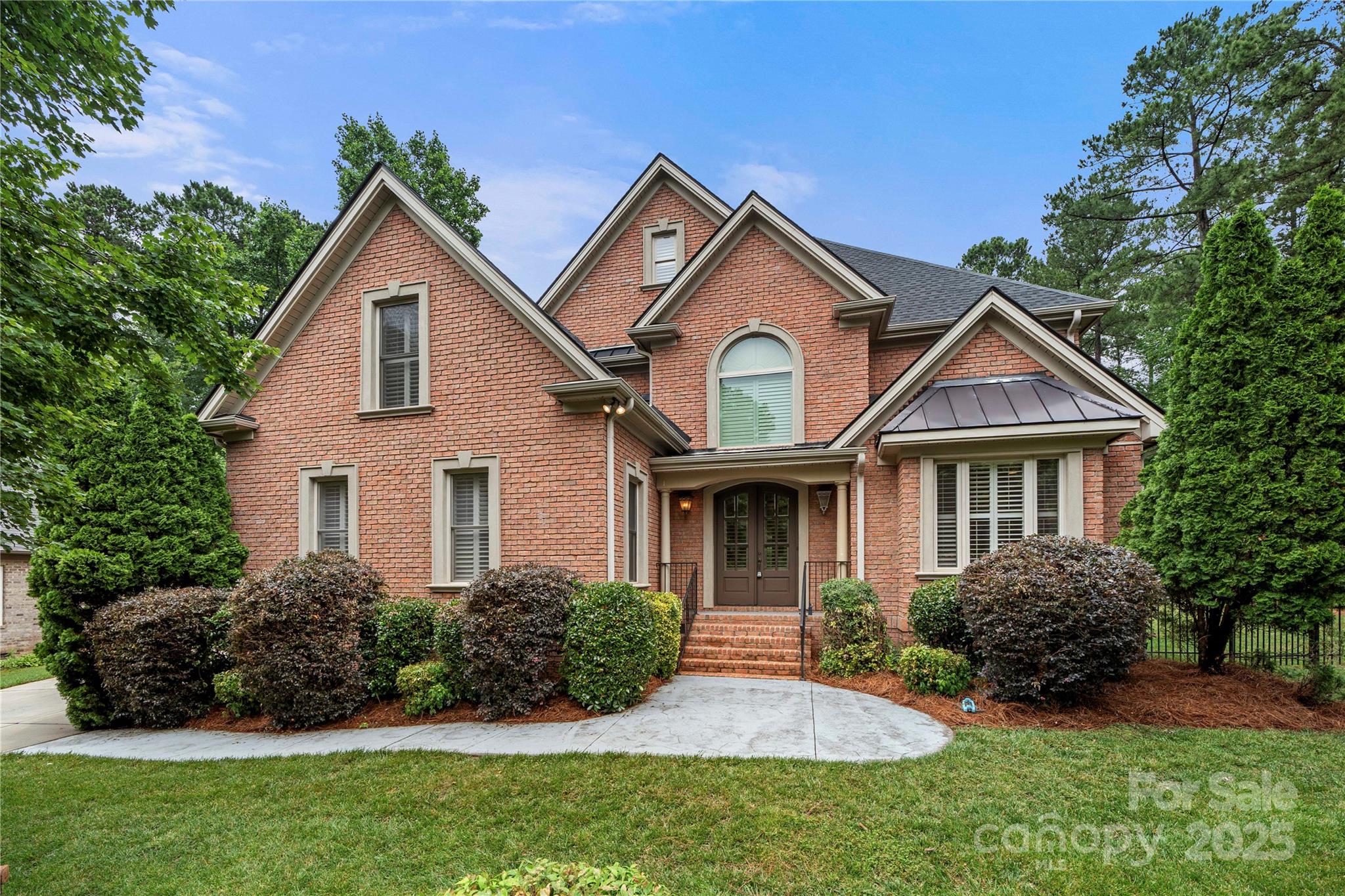 This elegant custom brick home nestled in the desirable lakeside community of Heron Cove is surrounded by mature landscaping offering exclusive tranquility. As you step inside you'll be greeted by rich architectural details, including inlaid hardwood floors, coffered ceilings & plantation shutters throughout. Main level features a spacious living room with a fireplace, formal dining area & second bdrm suite perfect for guests. Upstairs, a versatile office boasts a 2nd fireplace. Enjoy the serene outdoors from the screened-in porch, complete with a fireplace overlooking a private lush backyard. Detached garage is perfect for a workshop. Trim lights installed throughout front. The roof was replaced in 2023 & the entire interior has been freshly painted agreeable gray. Community amenities include a pool, playground & access to Lake Wylie for kayaking, canoeing, or paddleboarding. Award-winning Clover School District with easy access to CLT Airport, parks, trails, shopping & dining.