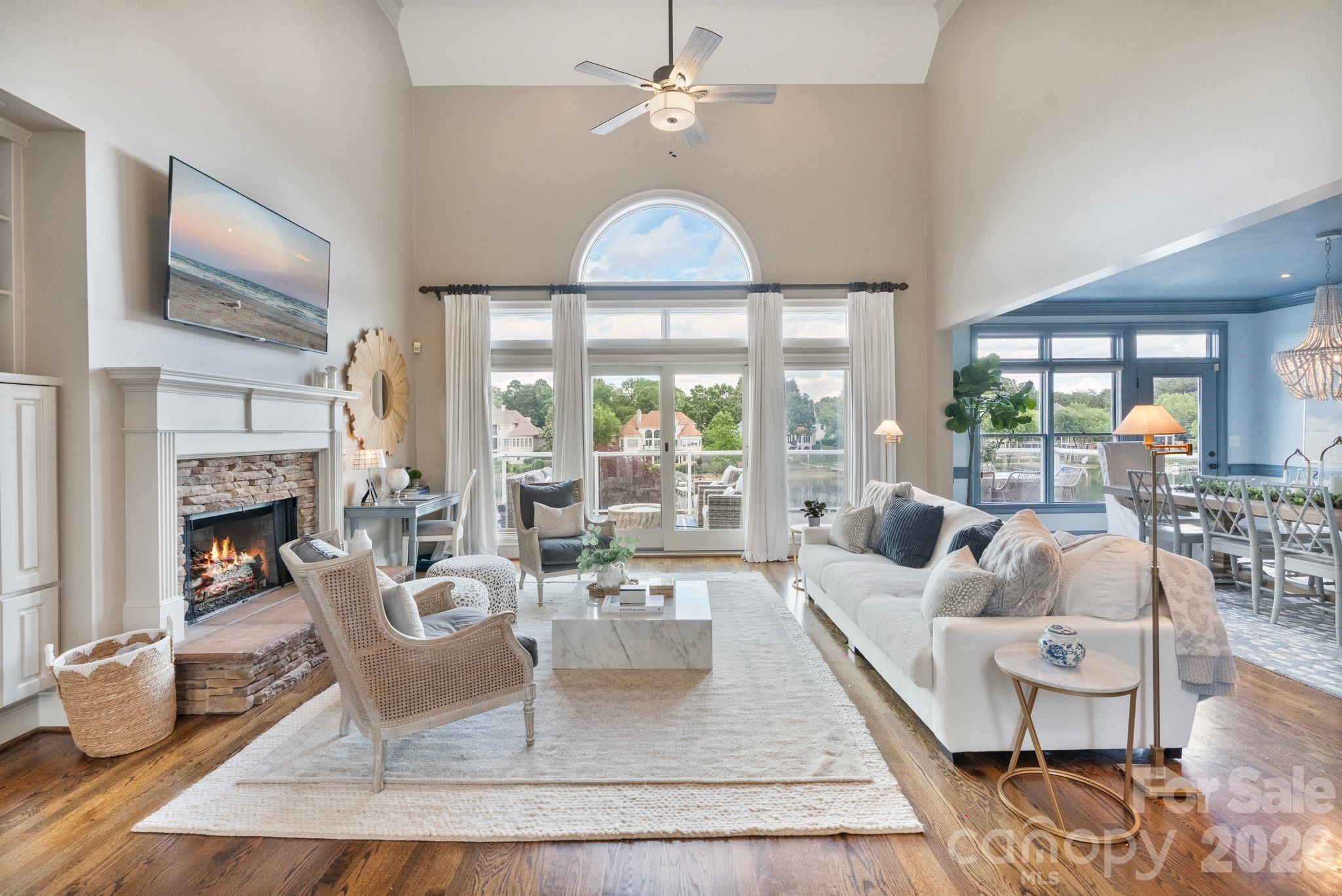 Stunning lakefront home in The Peninsula with wide Lake Norman views and boat slip with lift. Tucked at the end of a quiet cul-de-sac, this beautifully updated residence is designed to maximize seamless indoor-outdoor living with expansive walls of windows framing breathtaking water views throughout the main living areas. The renovated main level features a chef’s kitchen with premium Thermador appliances, open-concept living spaces, and a luxurious primary suite with updated spa-inspired bath and stunning lake views. Step outside to an expansive terrace perfect for entertaining or relaxing lakeside. Upstairs offers two bedrooms plus an optional 6th bedroom/bonus room. The finished walk-out basement includes two additional bedrooms, full bath, and versatile wet-storage room with additional laundry ideal for lake gear and storage. Flat manicured backyard with direct lake access and boat slip just steps away. Room for a pool with preliminary PPOA approval. Golf cart to The Peninsula Golf Club to enjoy golf, tennis, pickleball, fitness center, pool, and clubhouse amenities (membership separate). Rare opportunity to enjoy refined waterfront living in one of Lake Norman’s most desirable communities.