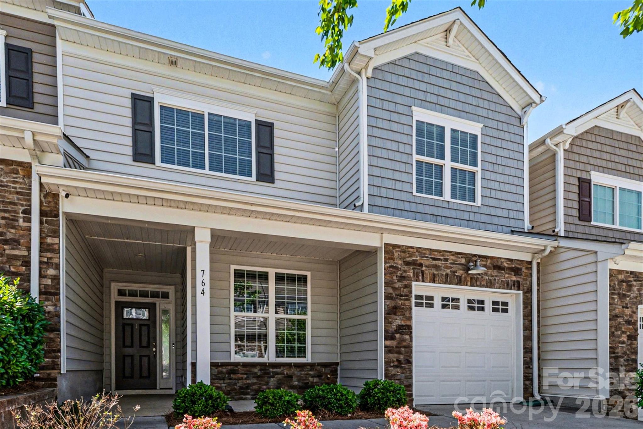 Beautifully maintained townhome priced below tax value in the highly sought-after Waters Edge community, backing to Lake Wylie. Filled with natural light, this home offers a warm, inviting atmosphere from the moment you arrive.

The main level features a versatile bedroom or home office and an open-concept design that seamlessly connects the great room, dining area, and kitchen—perfect for both everyday living and entertaining. The kitchen showcases granite countertops, a classic subway tile backsplash, and flows effortlessly into the main living spaces. Luxury vinyl plank flooring and elegant transitional archways add style and continuity throughout. Step outside to a privately fenced patio, ideal for relaxing or hosting, complete with an electric SunSetter awning.

Upstairs, the spacious primary suite includes dual vanities, a custom tile shower with a built-in bench, and a walk-in closet with direct access to the laundry room, which features a utility sink. A generous landing leads to two additional bedrooms and a full bath.

Ideally located less than 10 minutes from downtown Belmont and approximately 7 miles from Charlotte Douglas International Airport, this home offers both convenience and connectivity.

Enjoy low-maintenance living with water service and front lawn care included through the HOA, along with access to a community pool, walking trails, and additional amenities. With numerous upgrades throughout, this home is truly move-in ready and a must-see.