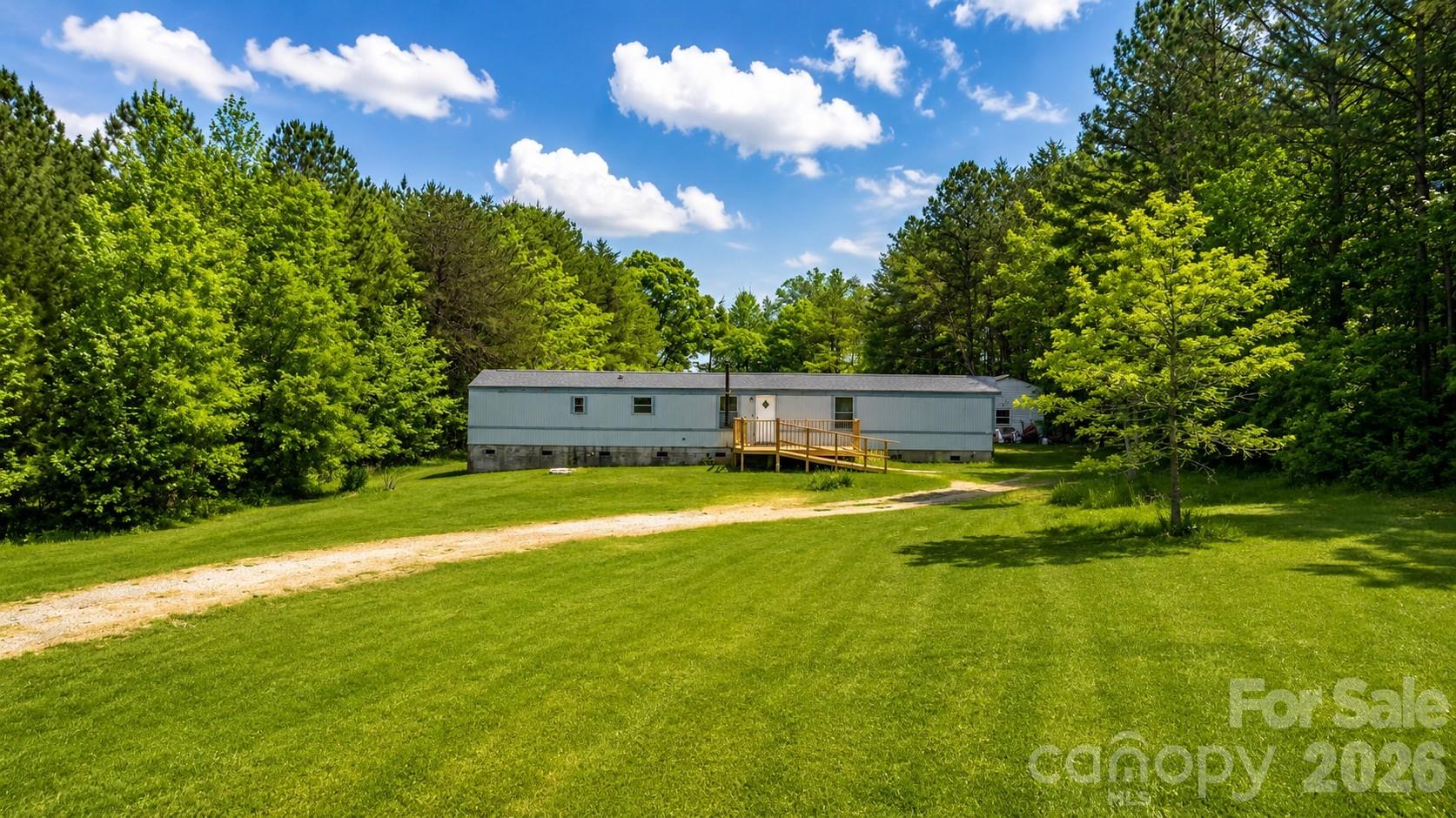 Situated on approximately 2 acres in a quiet rural setting, this 3-bedroom, 2-bath manufactured home offers a great opportunity for investors or buyers seeking space and privacy. The home features a functional layout with a spacious living area, kitchen with dining space, and split bedroom design. Enjoy the freedom of no HOA and plenty of room for outdoor activities, parking, or future improvements. Conveniently located with easy access to Cherryville, Lincolnton, and surrounding areas. Property is being sold as-is and offers excellent potential for renovation, rental, or replacement with a new home.