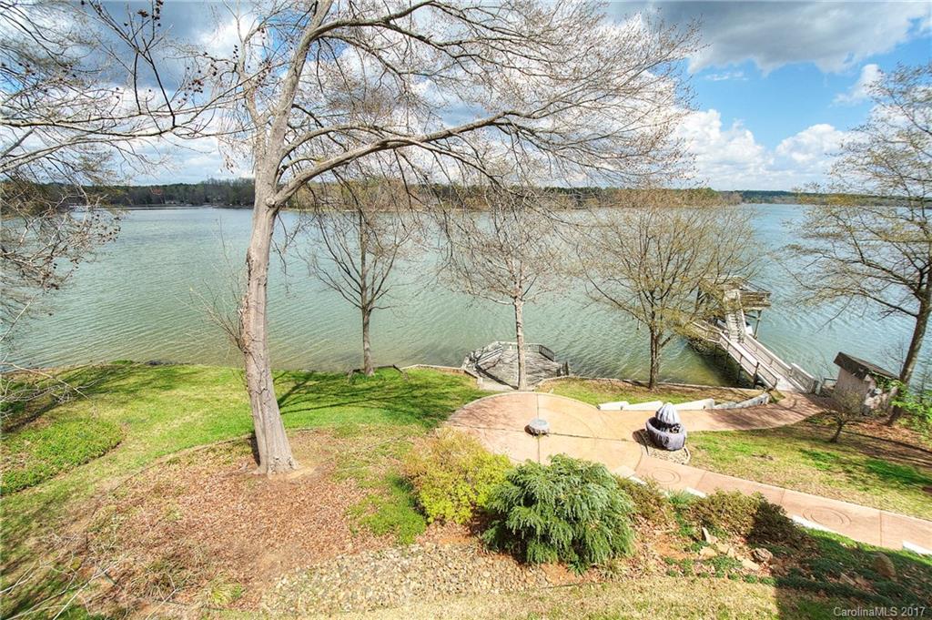 Designed to enjoy the lake and outdoors, this waterfront home offers a 180-degree view of the Big Allison channel of Lake Wylie. Get ready to entertain: Outdoor kitchen, hot tub, fire pit, plus covered dock w/ lift and sundeck! Gourmet kitchen w/ Viking stove, Sub-Zero refrig, and a wine cellar. Main level master has gorgeous lake views plus luxury bath. 2 bedrm on lower level, bath w/ steam shower. Handyman's workshop, efficient geothermal heat & whole house generator. Excellent Clover schools!