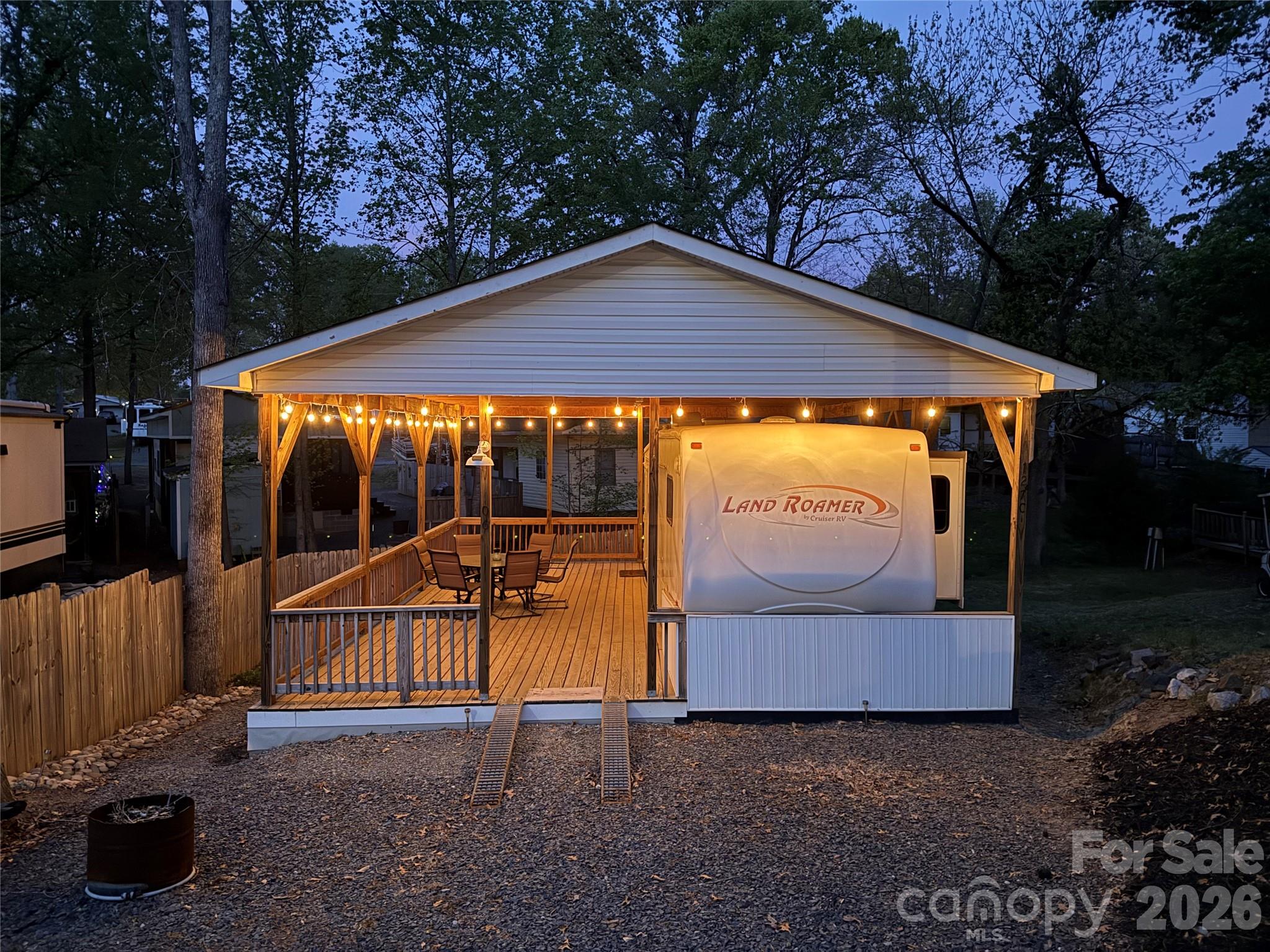 This 30' 2007 Land Roamer by Cruiser RV 5th wheel with 2 slides is ready for summer fun. Nice detail with the bead board work at the end of the camper. Camper couch and dining table both make beds for additional sleeping. King size bed with plenty of walking space and good size storage. Fabulous covered deck with block foundation. This unit can be used like it is or is ready for the addition you like to make it the perfect "Happy Place" for your family.  There is a ramp to park your golf cart on the porch. Roof is approx. 6 years old. Yard Hydrant and metal storage building out back. Everything that is there is included. Oven needs a thermocoupler. 
All buyers must be with a realtor to gain access to the community.