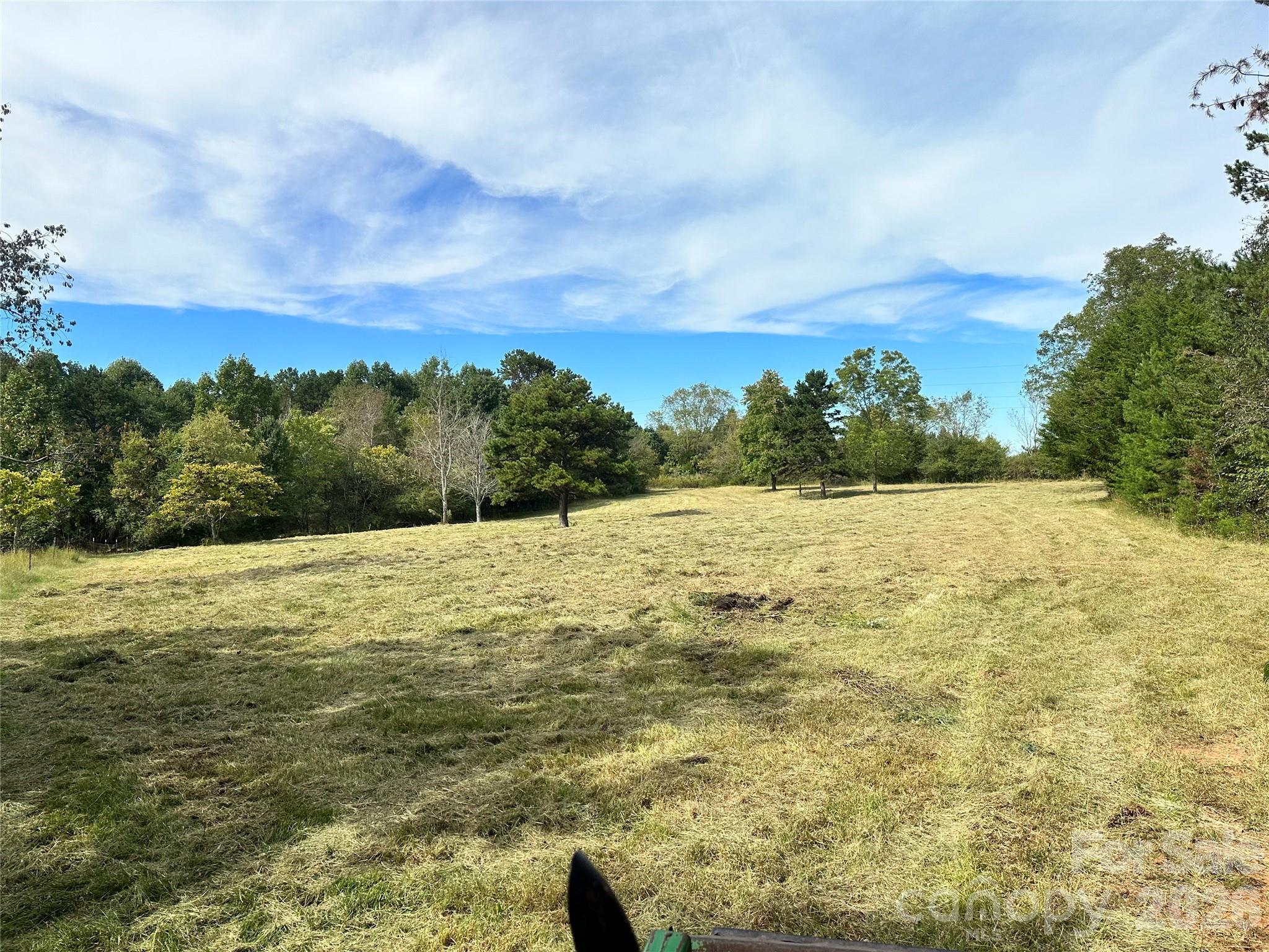 30.76 acres in northern Iredell County with close access to I77 at Exit 65.  This tract is mostly wooded with hardwood trees but does have a few acres already cleared near the 356' of road frontage.  Property also has a stream that has water year round and abundance of wildlife. Currently in forestry tax deferment and possibly has some timber value but no reports or appraisals of the timber have been completed.  Public water thru Iredell Water Corporation is available on Eagle Mills Rd per seller.  **Aerial drone pictures with red lines are not actual property lines and just are a estimated for general reference.** Owner's home on Natures Way Ln adjoins the property and could potentially be purchased in addtion to the land if interested.  Adjoing home is showed in the pictures.  Property road frontage is located between 601 Eagle Mills Rd and 627 Eagle Mills Rd.