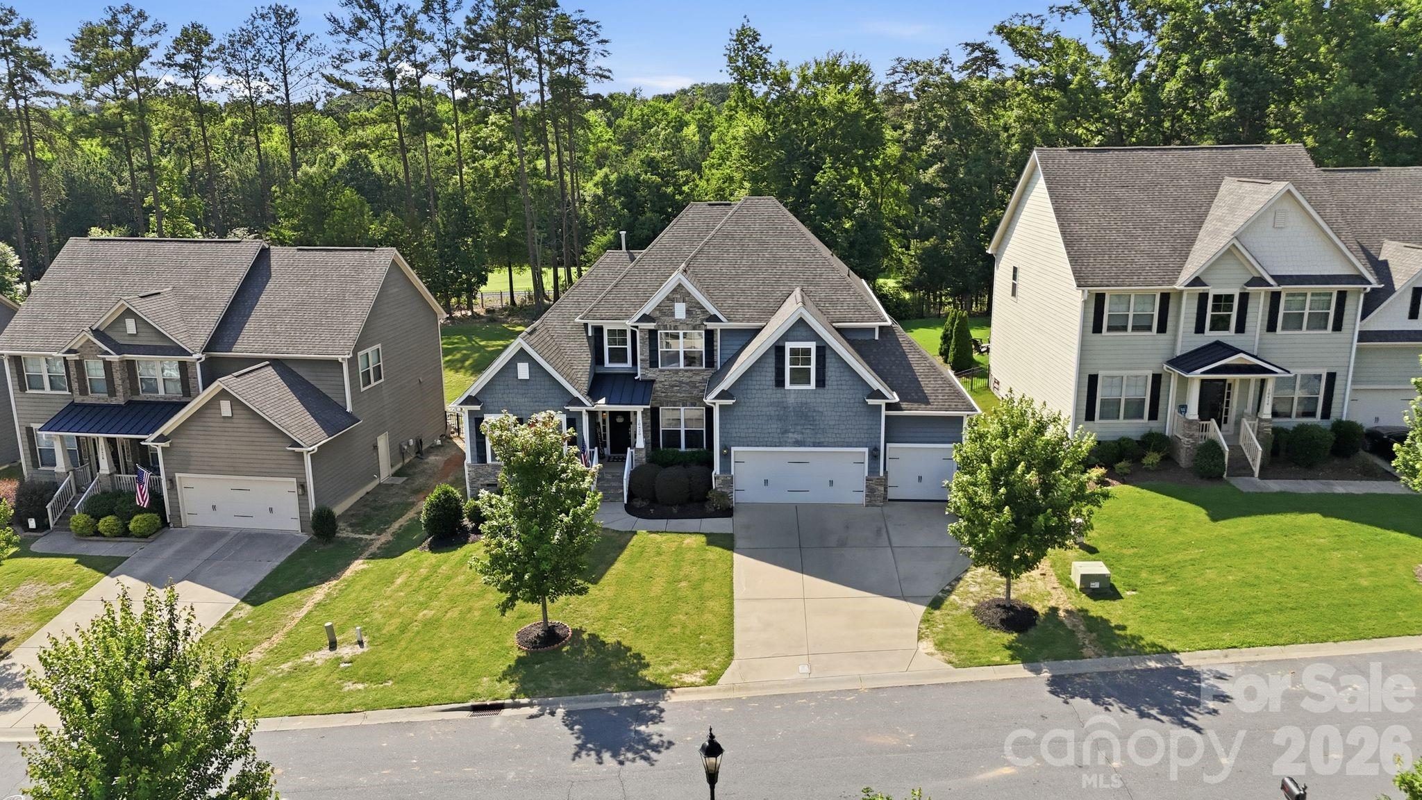 Welcome to this exceptional golf course home in The Palisades, one of Charlotte's premier resort-style communities. Perfectly positioned overlooking the 6th fairway, this beautifully maintained Knotts Builders home blends luxury, comfort, and outdoor living. 

Built in 2016, the thoughtfully designed floor plan features hardwood floors throughout the main living areas, abundant natural light, and an open-concept layout ideal for everyday living and entertaining. The gourmet kitchen showcases granite countertops, a large center island with seating, ample cabinetry, and seamless flow into the living and dining spaces. 

The main-level primary suite offers a tray ceiling, spacious walk-in closet, and spa-inspired bath with granite countertops, dual vanities, and a glass walk-in shower. A laundry room with a utility sink adds convenience. 

Upstairs, you'll find three generously sized bedrooms, all with walk-in closets, plus a versatile bonus room and open loft area that can serve as a media room, home office, playroom, or additional guest space. 

Step outside to your private outdoor oasis overlooking the fairway. The fenced backyard is designed for entertaining with a stunning stone fireplace, built-in grilling station, and multiple areas to relax, dine, and gather with family and friends. 

Additional features include an oversized 3-car garage and a 240-volt electric vehicle charging outlet. 

Residents of The Palisades enjoy an unmatched lifestyle with resort-style pools, tennis and pickleball courts, walking and nature trails, playgrounds, sports facilities, and year-round community events. 

Whether you're enjoying morning coffee overlooking the course or hosting friends around the outdoor fireplace, this home delivers the lifestyle today's buyers are seeking.