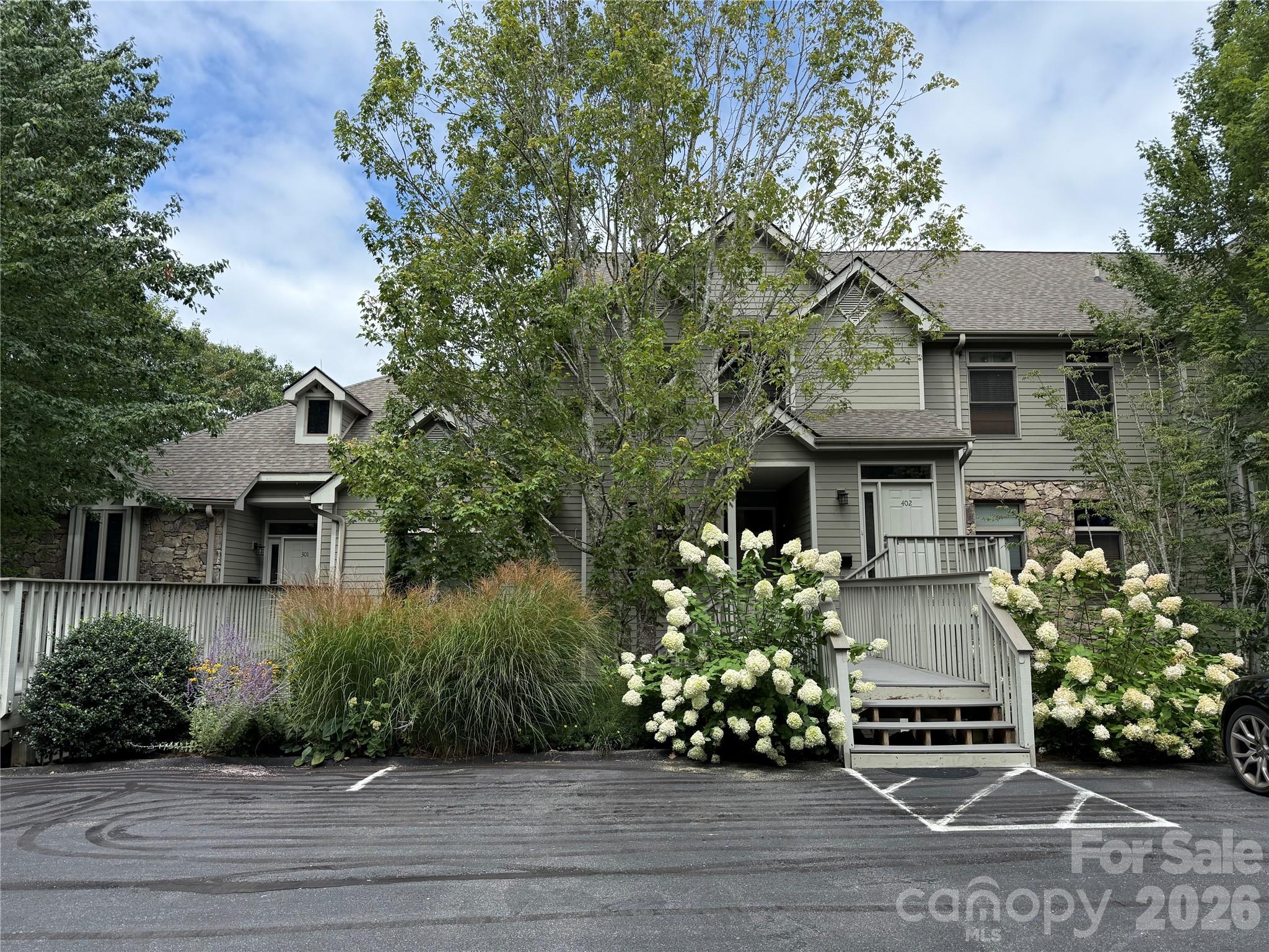Beautifully maintained 2BR/2BA condo in the desirable Stoney Falls community of MOUNTAIN AIR. This move-in-ready unit features hardwood floors in the main living area and is offered fully furnished with a few exceptions. Enjoy long-range, western-facing mountain views from the living room, private deck, and primary bedroom. The great room includes a stunning stone gas log fireplace with built-ins. Kitchen features newer stainless steel appliances and granite countertops. Convenient access from two parking areas and located within walking distance to Heritage Ridge Park. Owners enjoy access to multiple parks, hiking trails, and a private runway. Optional club membership offers access to golf, tennis, pickleball, dining, and more. Ideal as a full-time residence, vacation getaway, or short-term rental investment. Located just minutes from Burnsville and a short drive to Asheville, NC and Johnson City, TN.