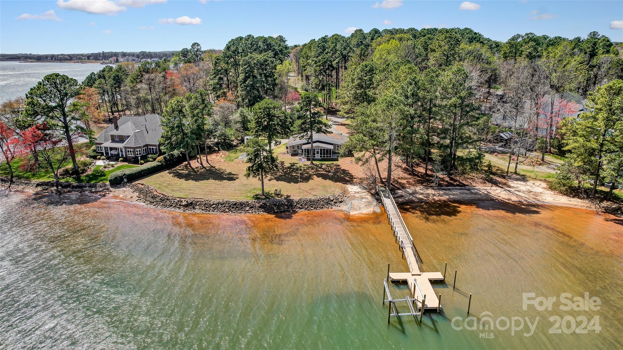 This is an excellent opportunity to own a lakefront lot with expansive views of the main channel on Luckey Point. The lot is almost an acre and offers stunning, panoramic water views. It boasts a sandy beach and a new dock with a lift. This property has 265 feet of shoreline and is in a prime location within Denver. The possibilities with this stunning lot are endless, with sunrise and sunset views. The peaceful community offers a tranquil escape from the hustle and bustle while conveniently located near restaurants and shopping. Deep water at the dock, perfect for all types of boats. The house is being sold as-is.
